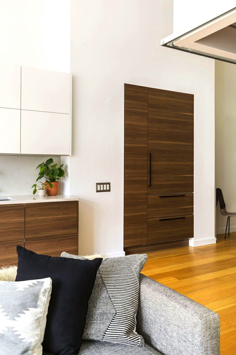 custom maple and white kitchen cabinets combo and open to living area and hardwood floors after renovation