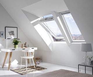 Open loft window in a white loft room with white desk.