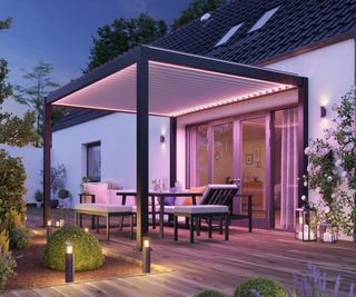 black aluminium pergola attached to house with patio doors beneath height of slatted roof