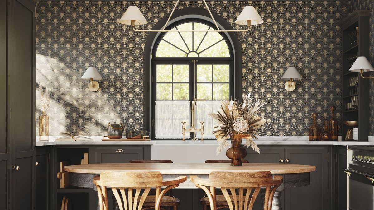 green and white wallpaper on wall with arched window in kitchen with green cabinets, white and gold lighting and wooden oval table and chairs