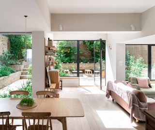 inside of extension with light wooden floor and stepped ceilings helping to define different zones including living and dining areas