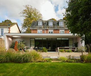 large single storey extension on rear of property housing indoor and outdoor living spaces
