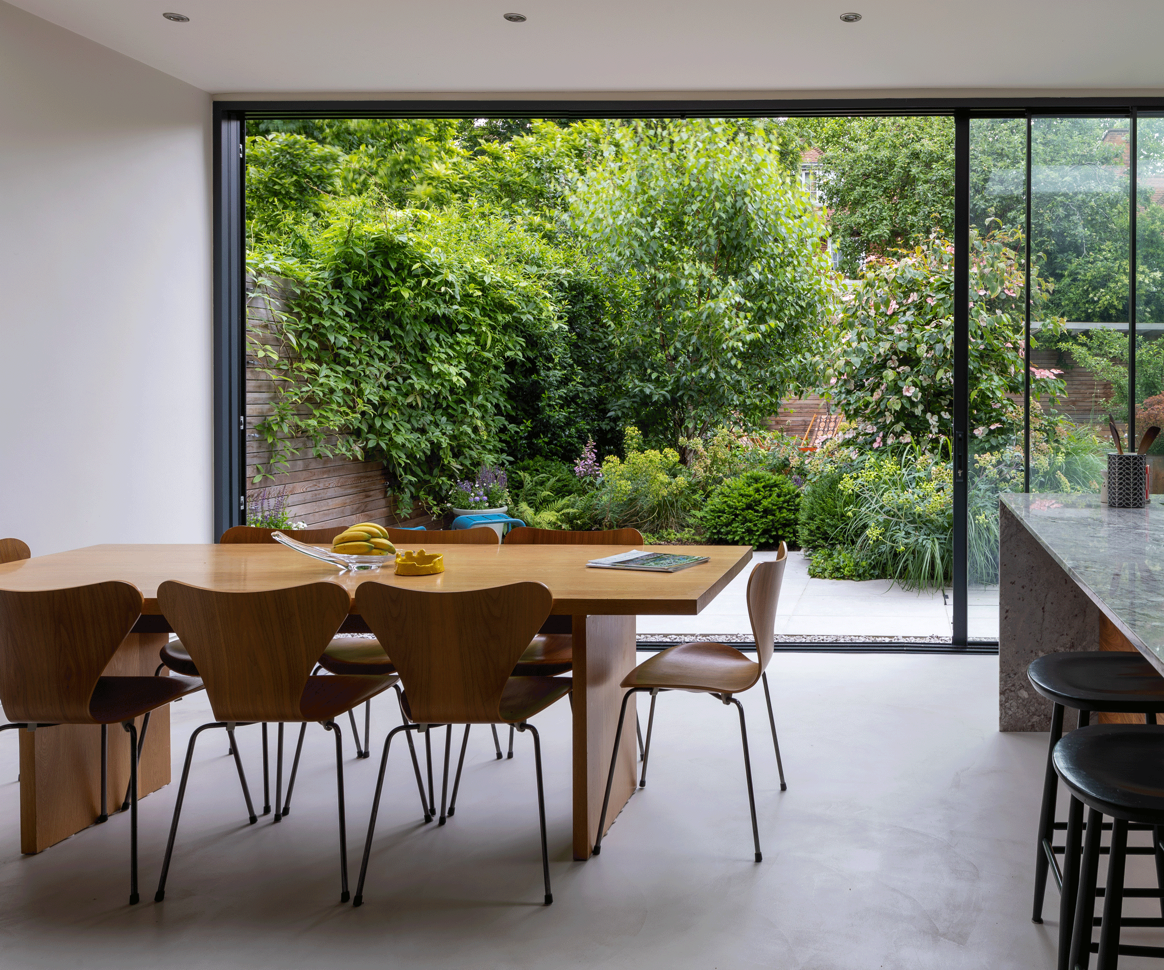 modern kitchen diner with glass sliding door into garden