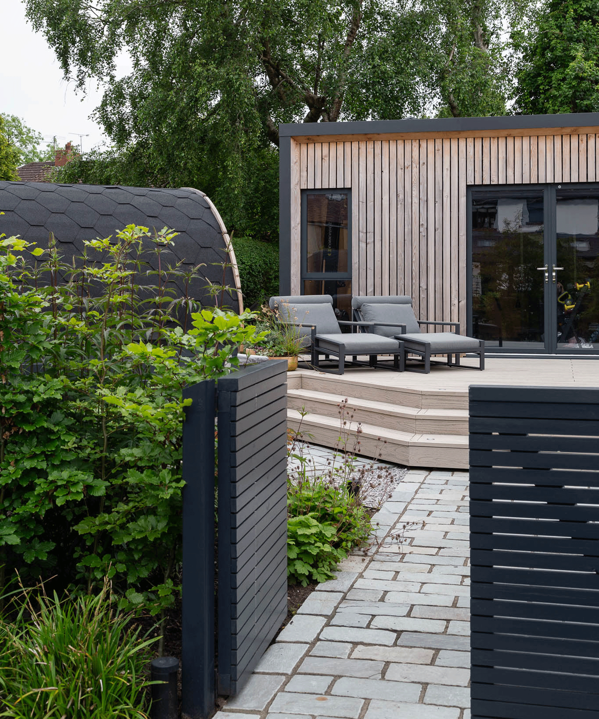 modern garden design with garden studio and loungers
