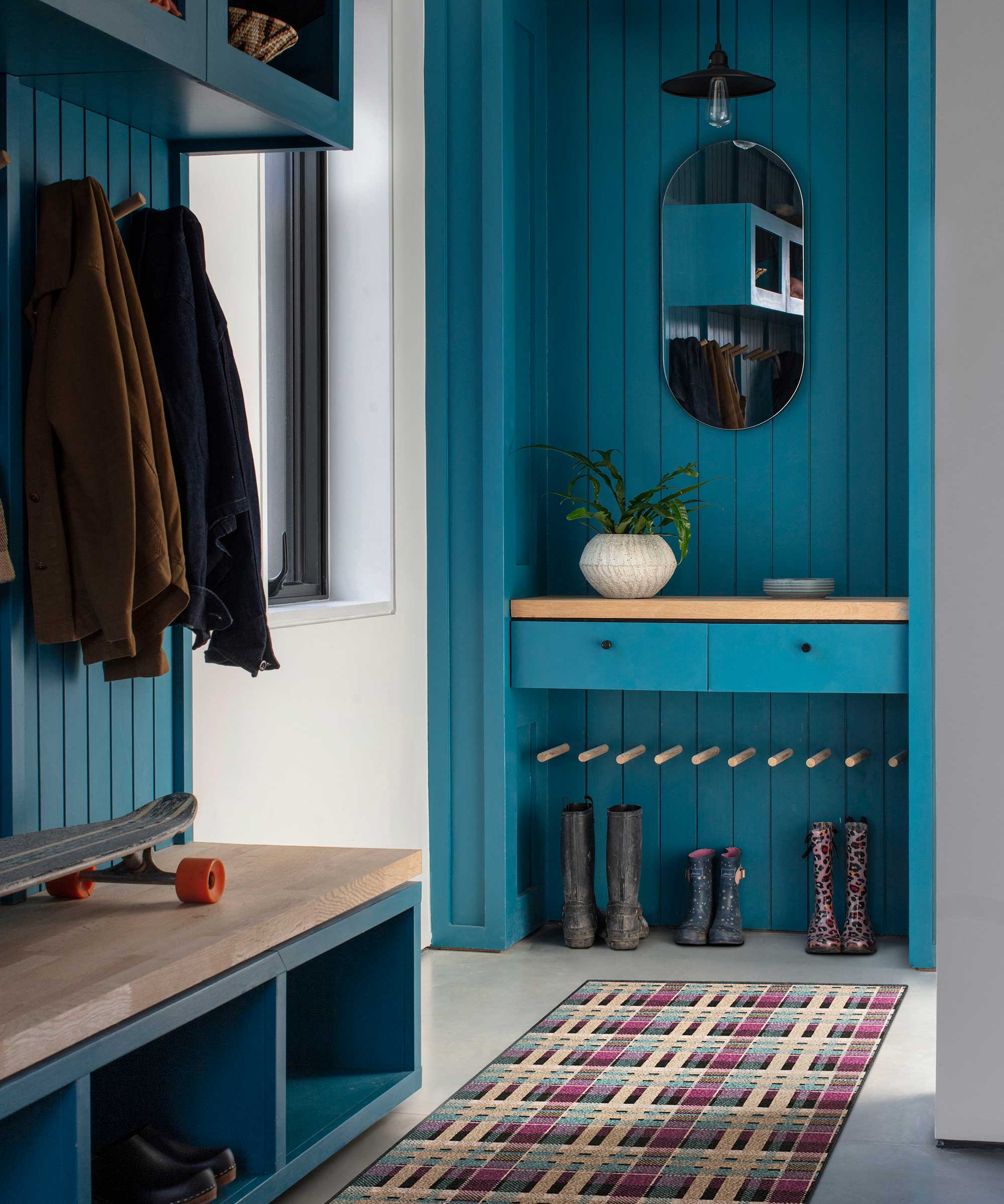bright blue boot room with wooden wall panelling