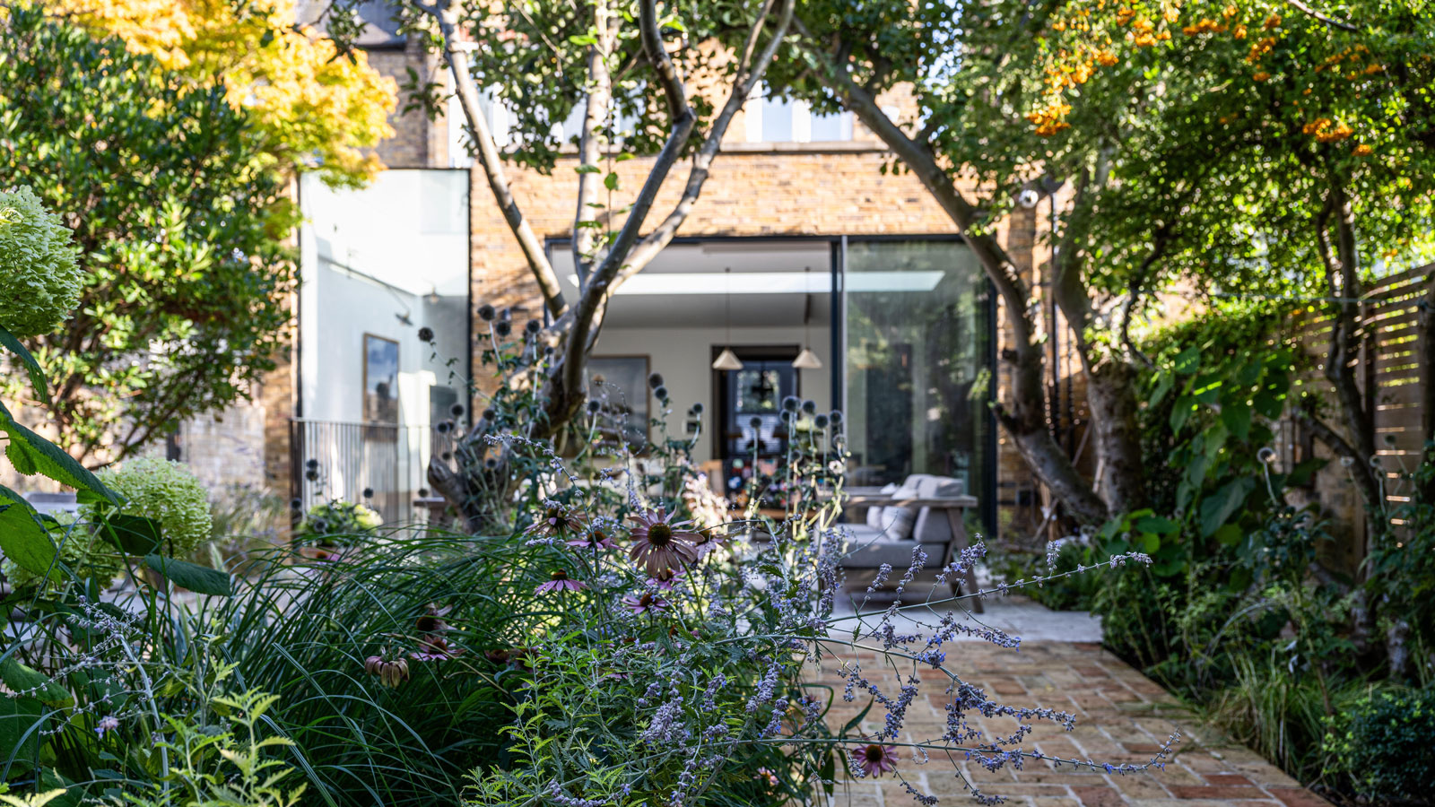 modern house extension with garden including trees and plants