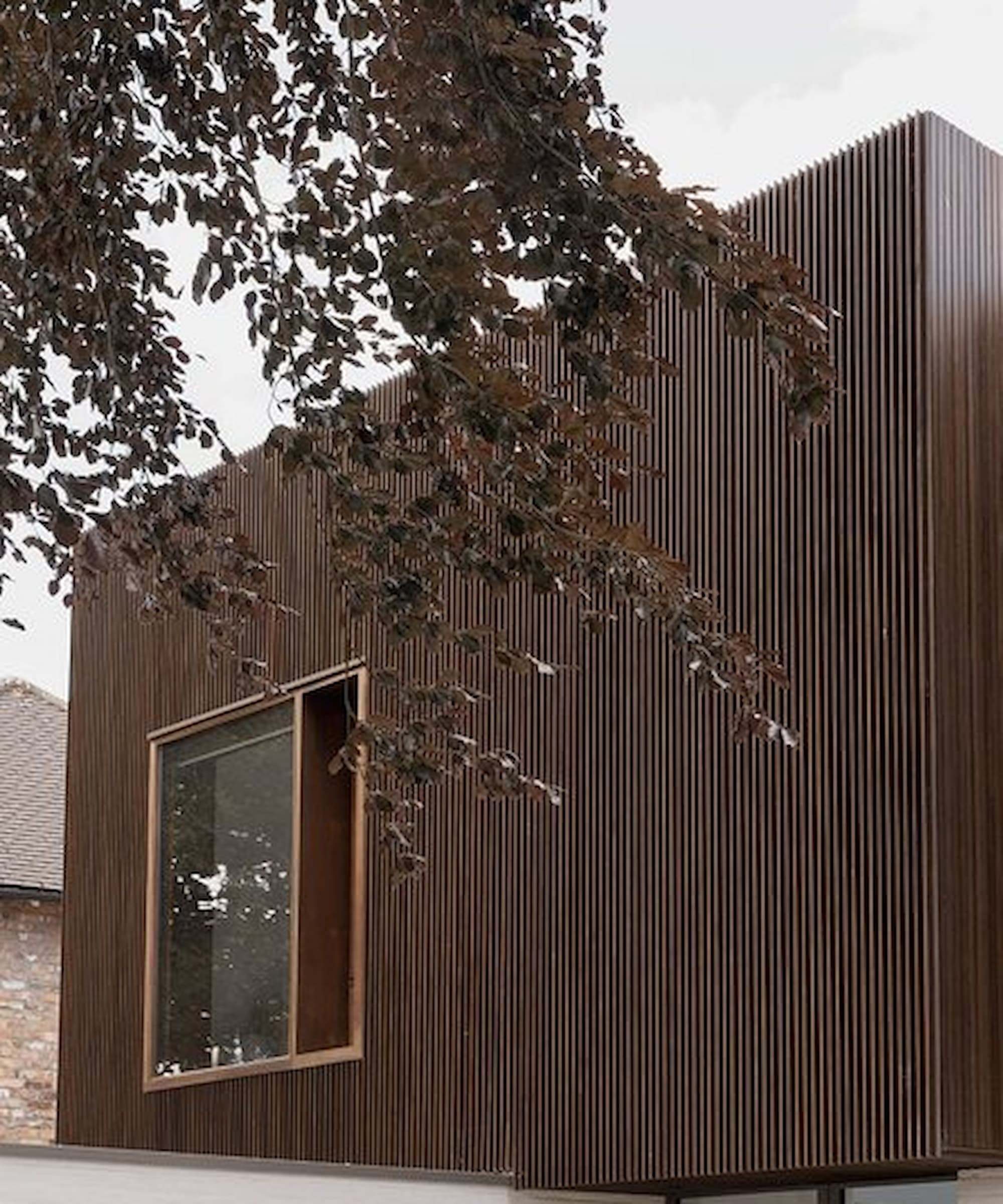 The exterior of an upstairs self build showing timber panelling