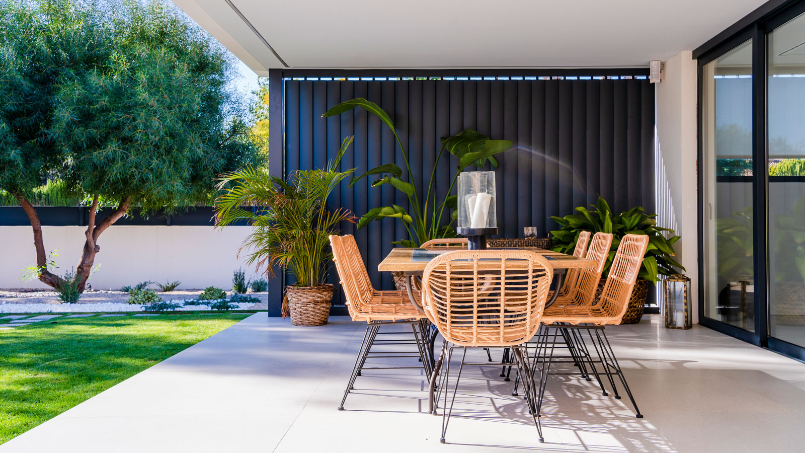 modern patio with outdoor dining set, plants and tree