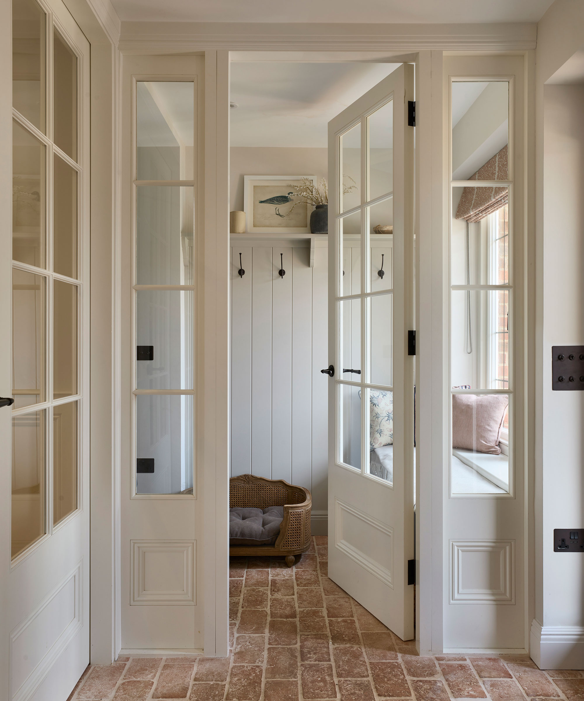 glazed doors leading to utility room with brick flooring