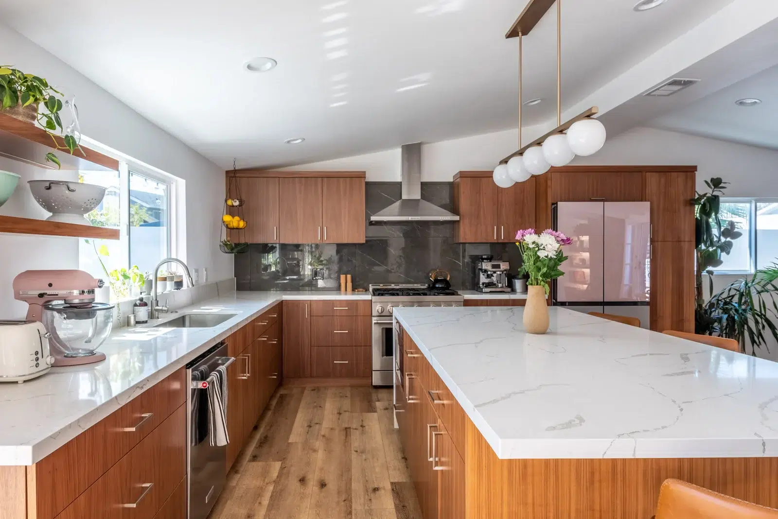 wood kitchen with vinyl flooring and black quartzite backsplash in home remodel in culver city