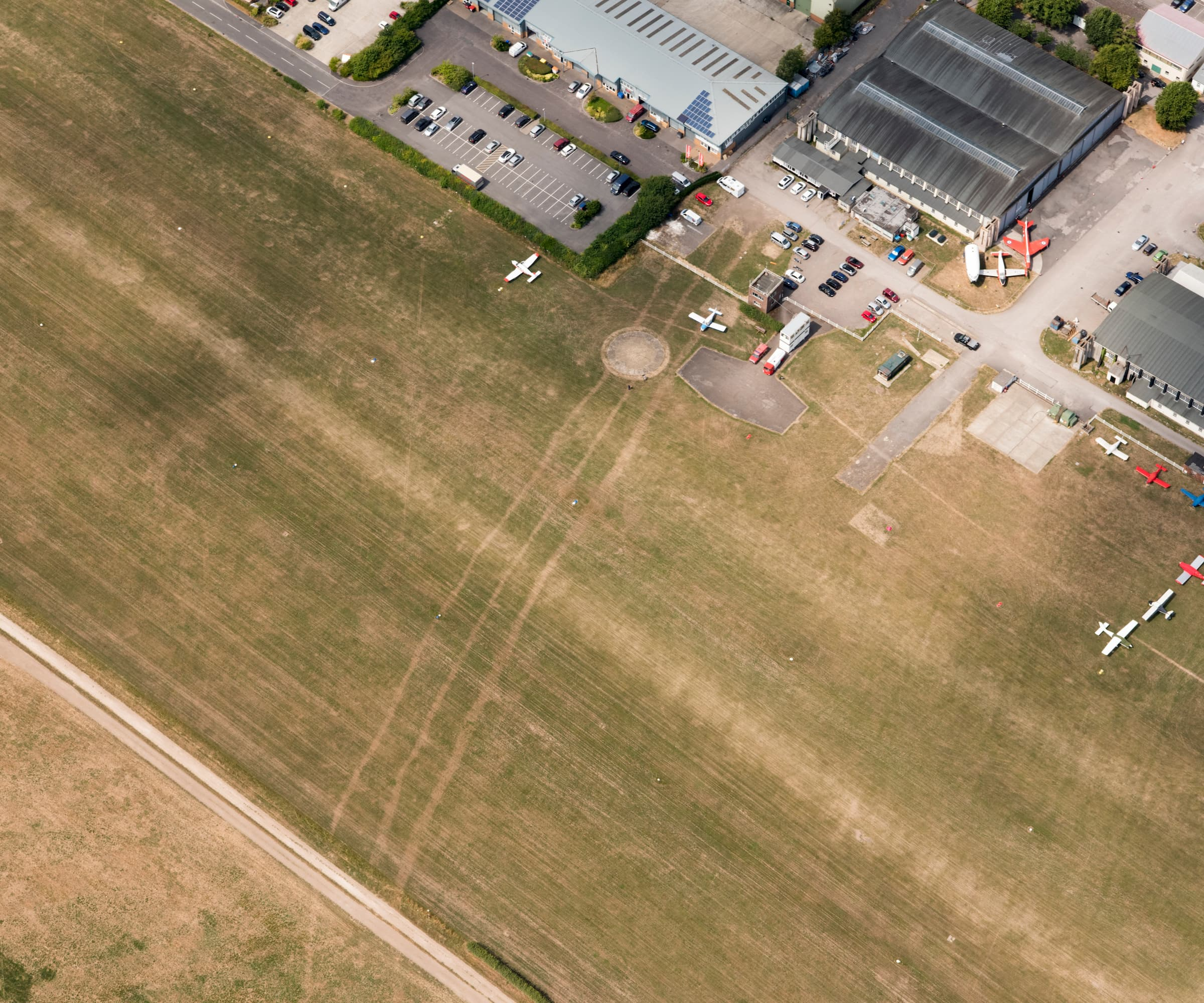 A large airstrip with three hangers