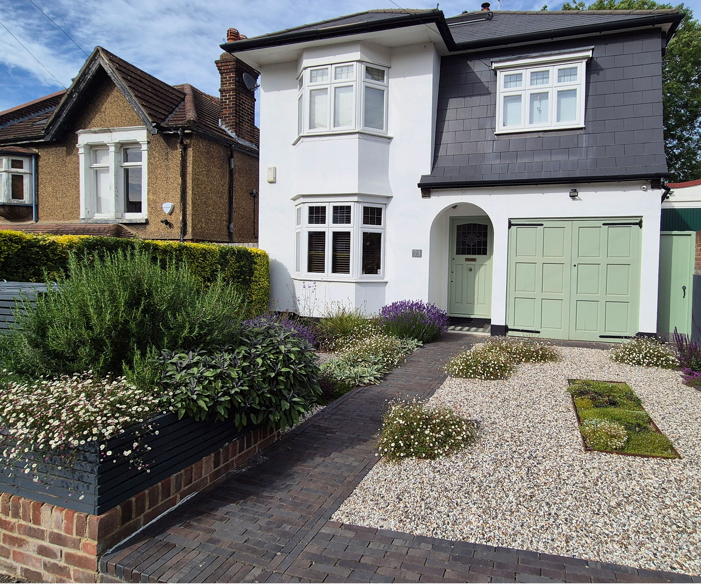 front garden design with gravel landscaping and wheelie bin screen