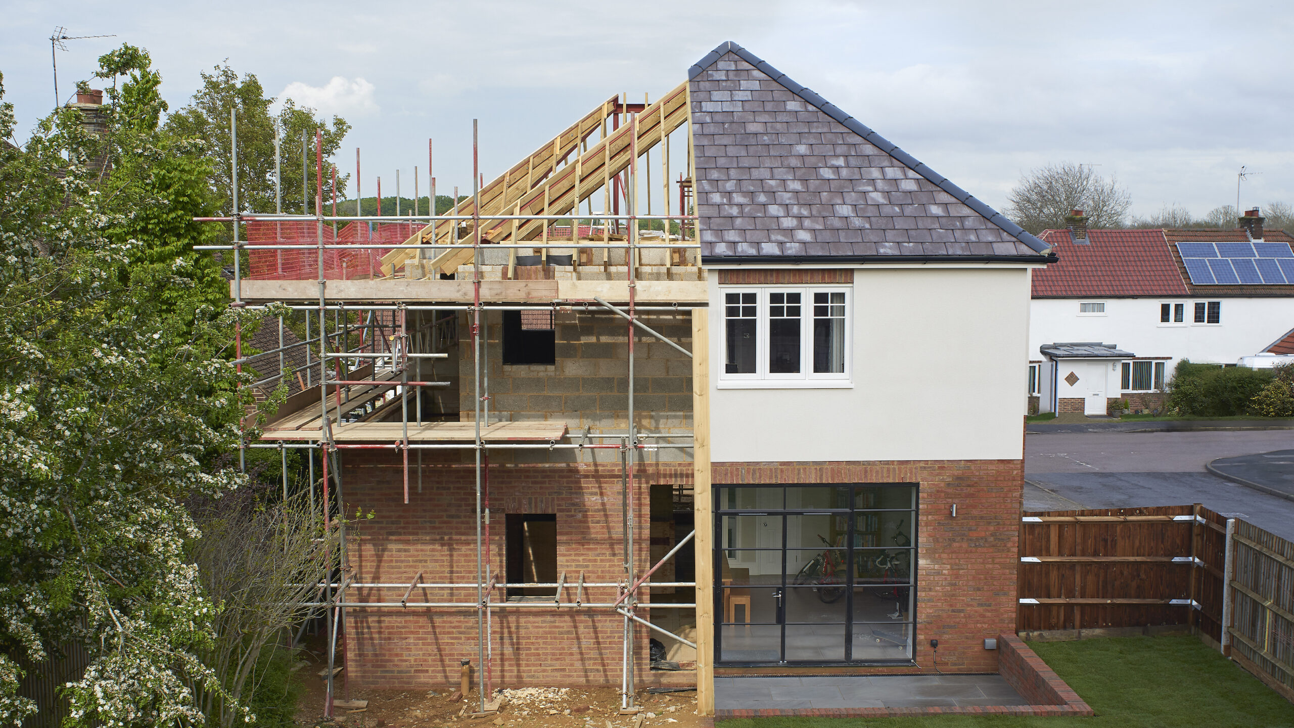 half built house with scaffold and timber frame