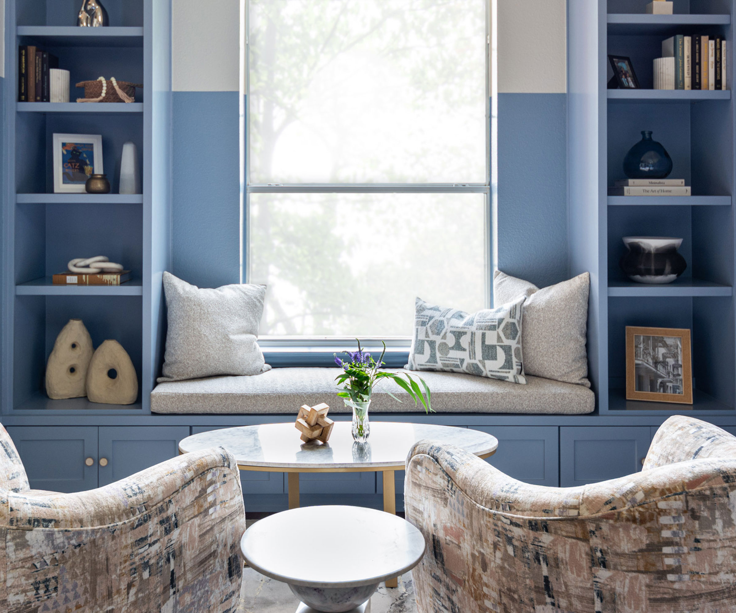 blue built-in book shelves with window seat