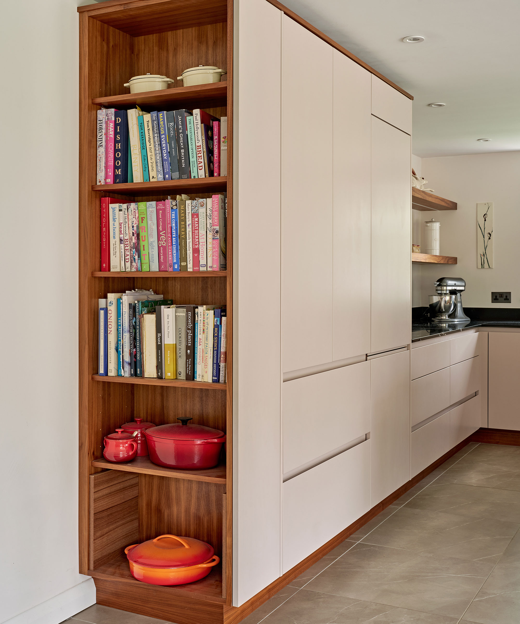 modern white kitchen with tall book shelves