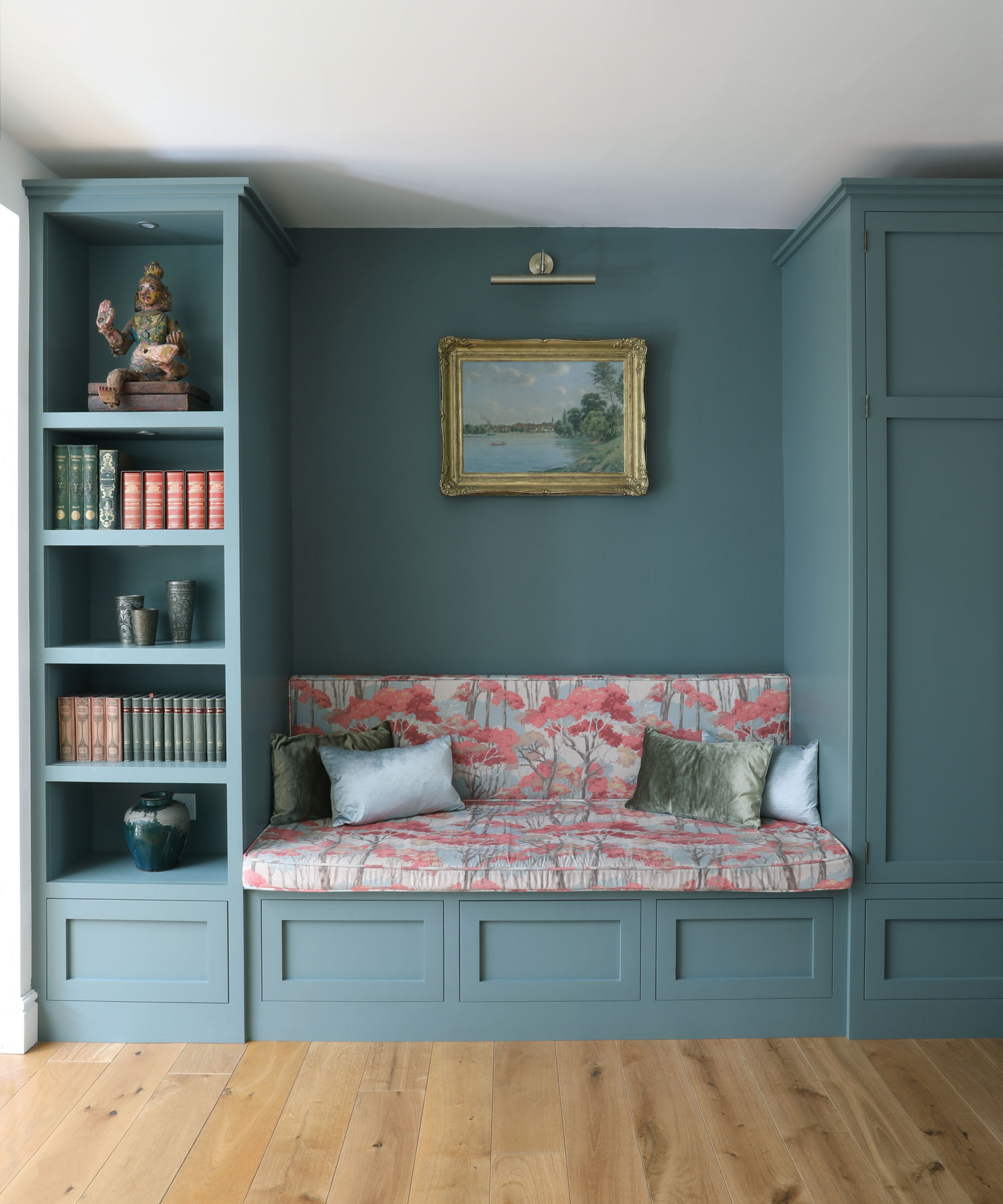 blue painted reading nook with book shelves