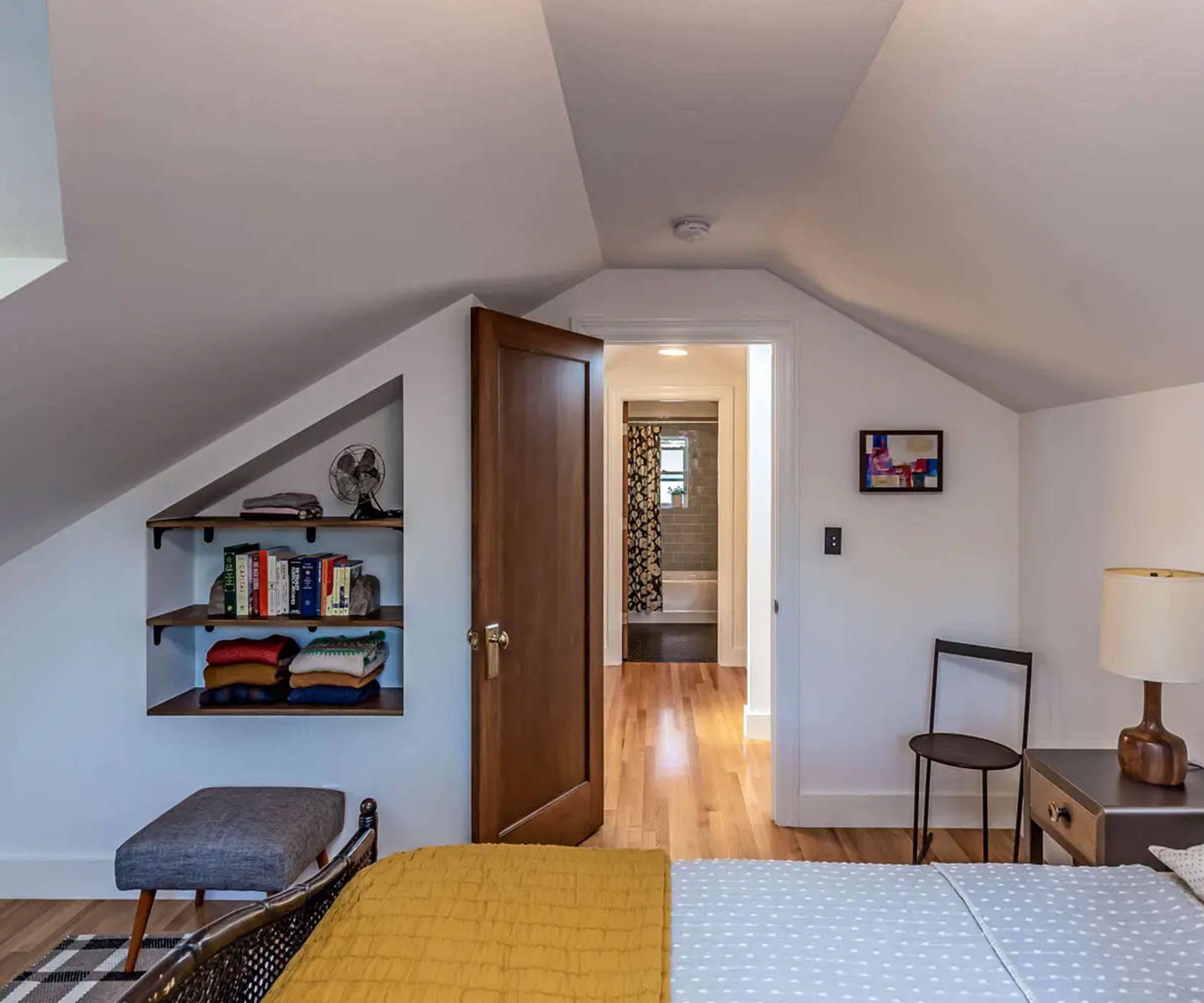 loft bedroom with alcove book storage