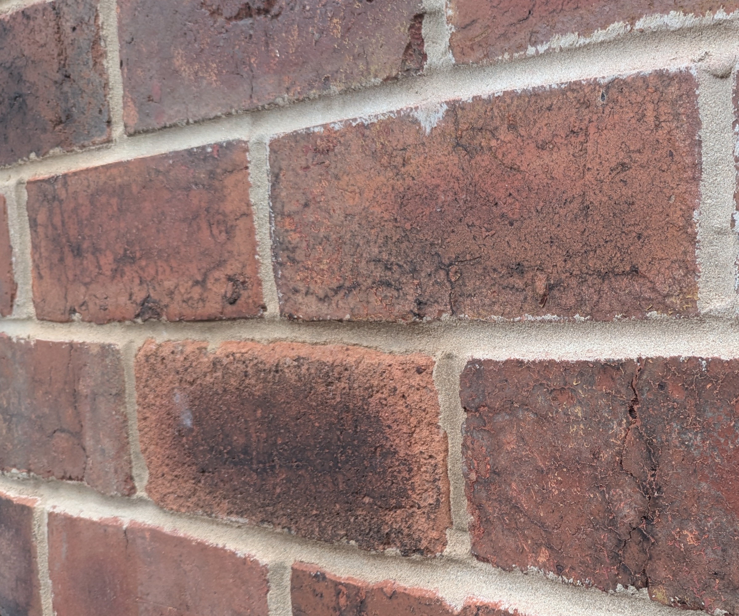 Brickwork with concave pointing, with the mortar curving inwards from the edges of the bricks