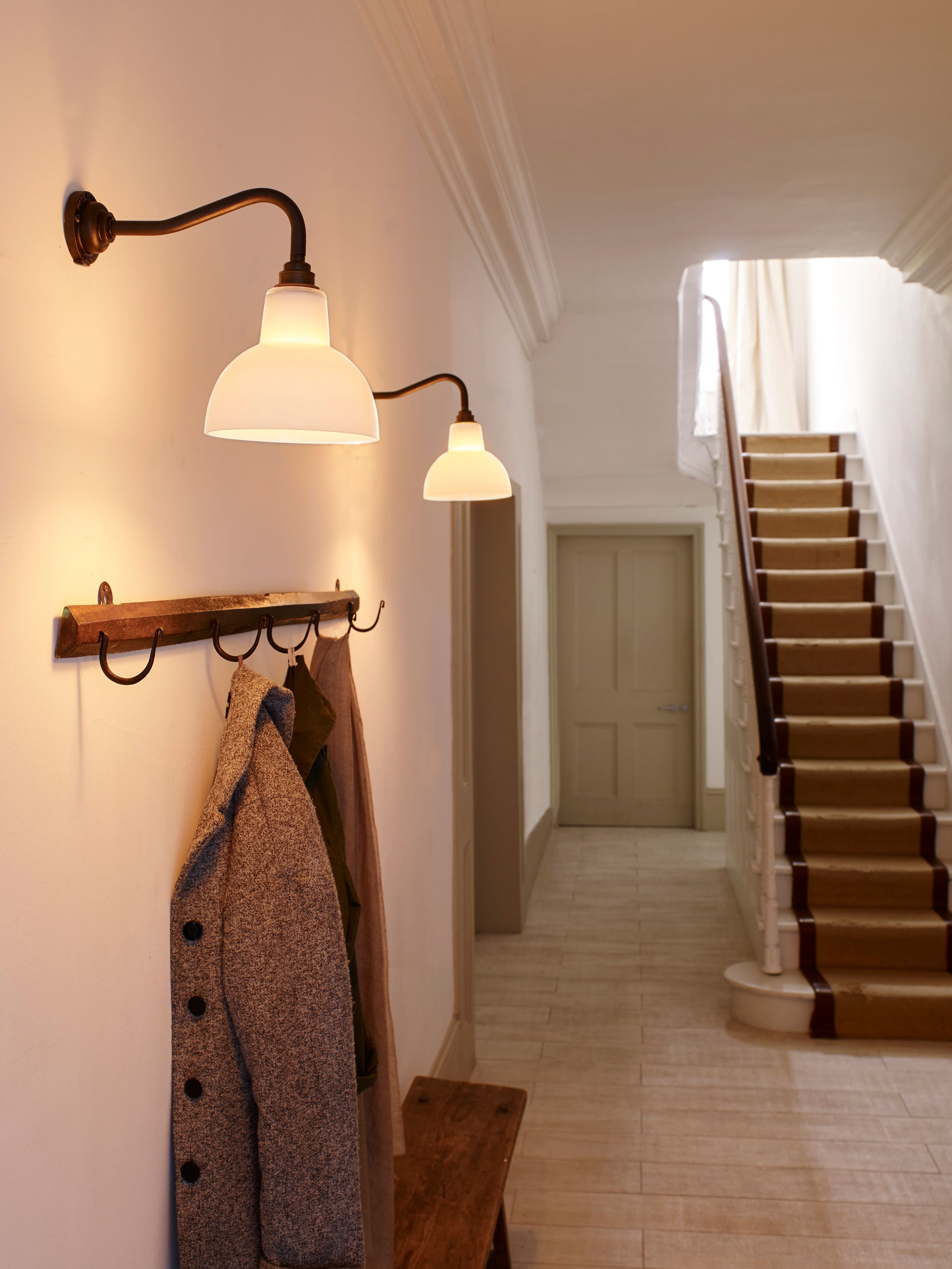 wall lights in a large, grand hallway