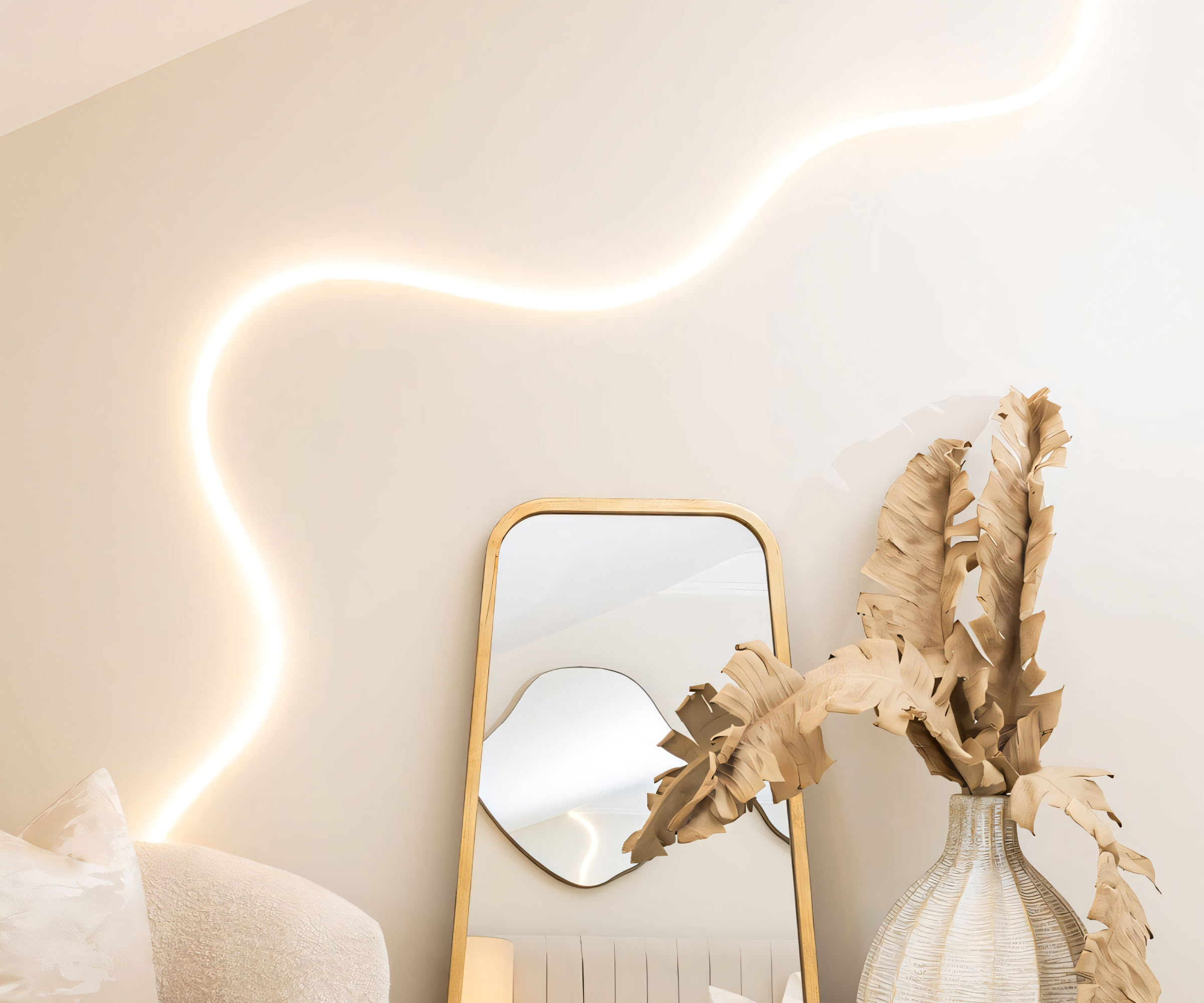 white LED flexible light strip on white wall above mirror and vase