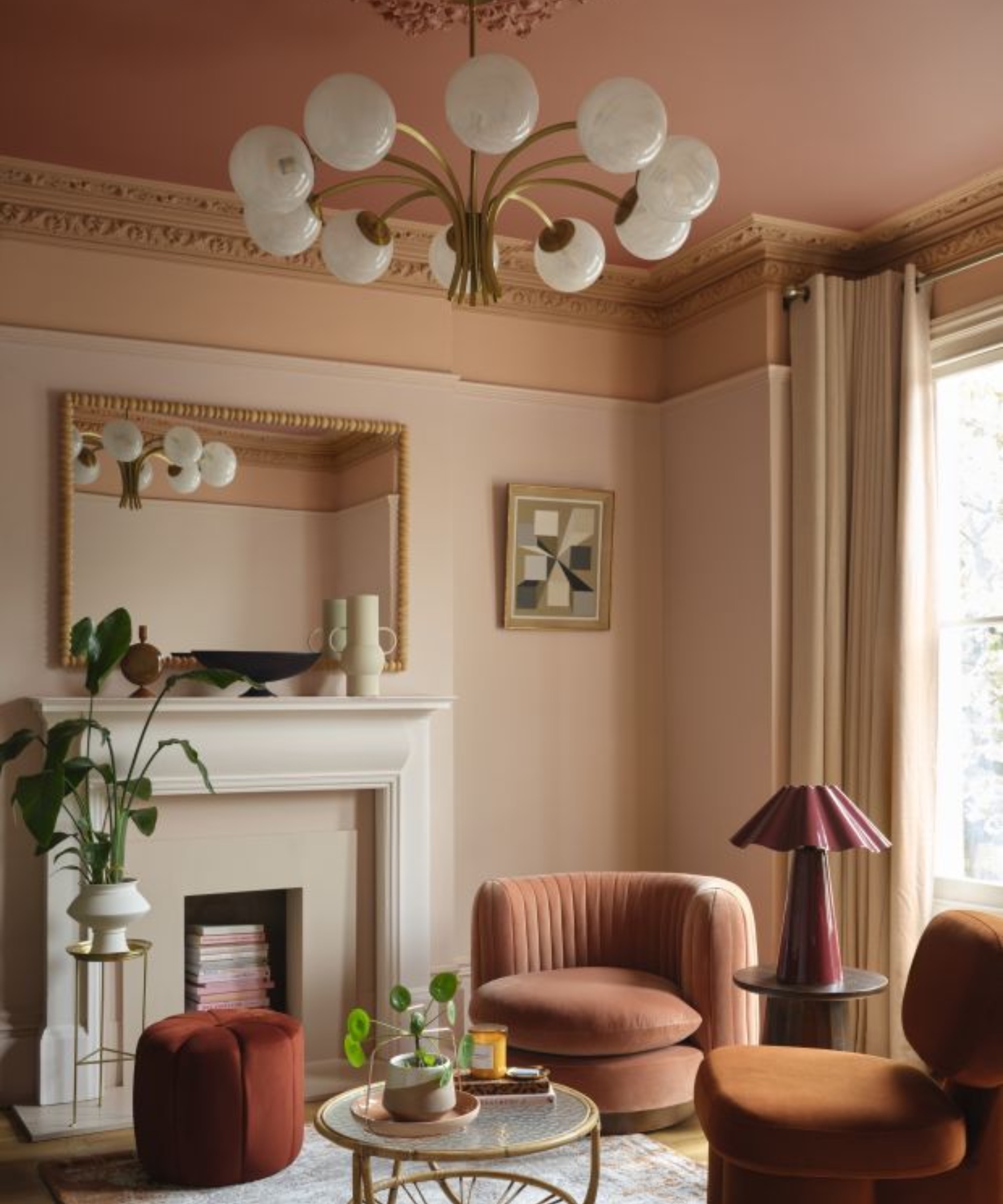 Peach living room painted in Benjamin Moore's Louisiana Hot Sauce CC-124, Firenze AF-225, Mrytle Beach 061, Queen Anne Pink HC-60 with rust swivel chair and fireplace
