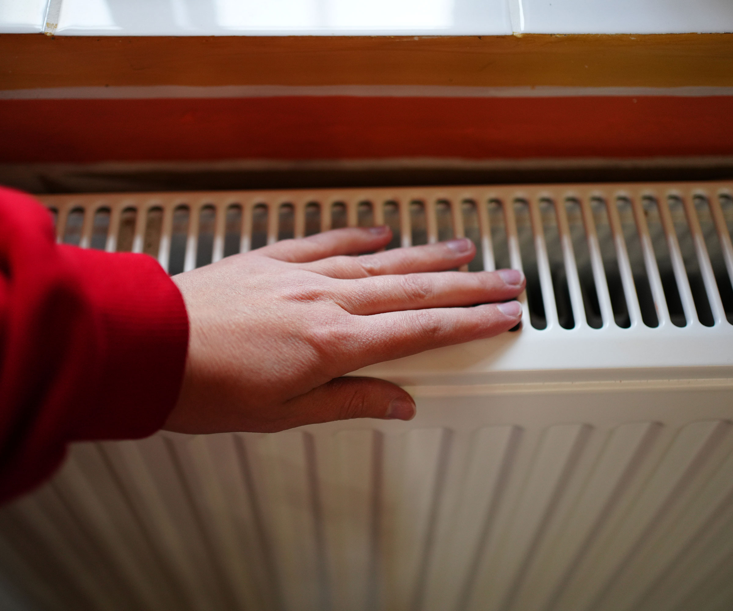woman's hand on radiator