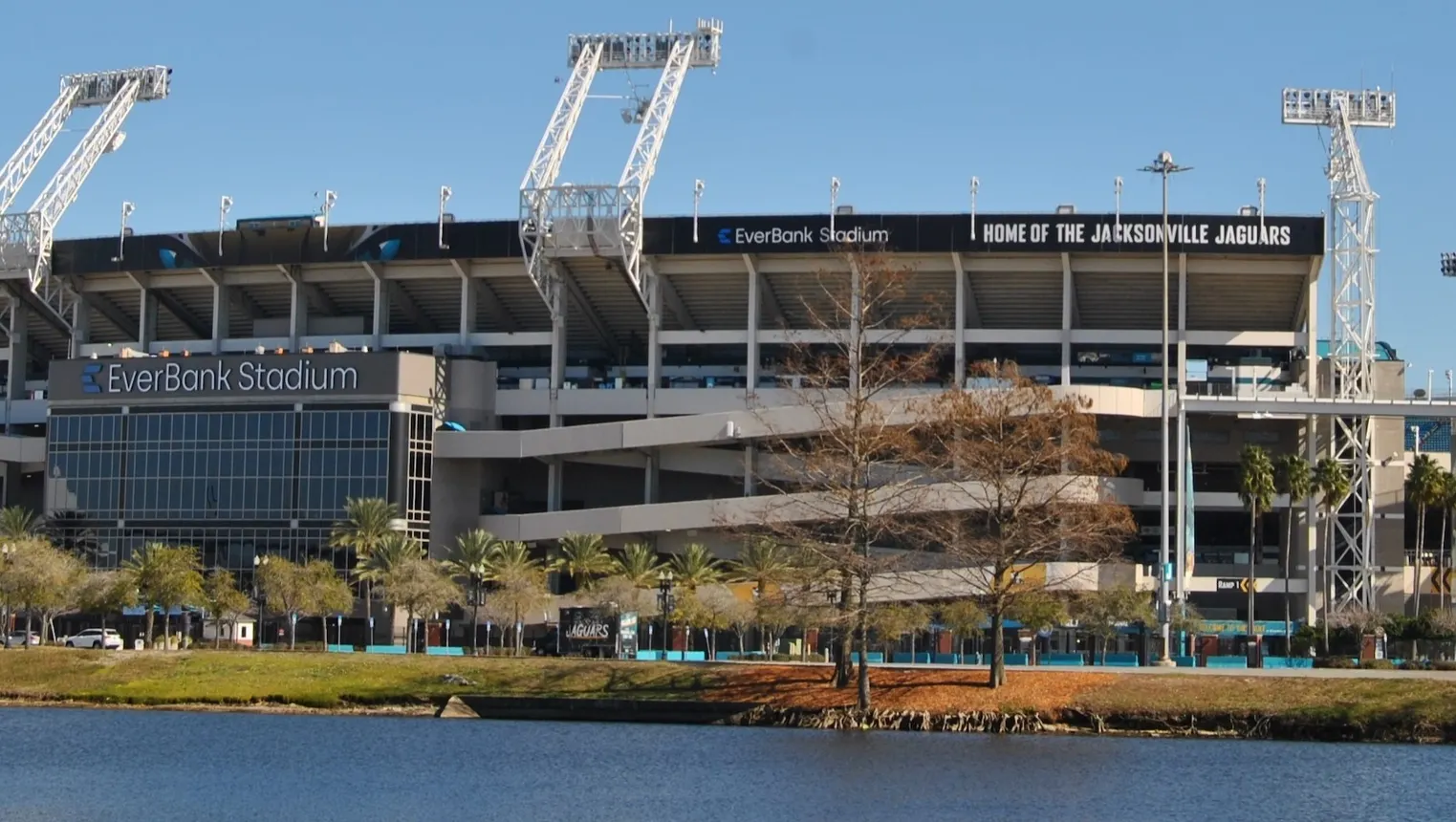 A shot of a stadium from across a body of water. The words "EverBank Stadium" can be seen on the front of the structure.