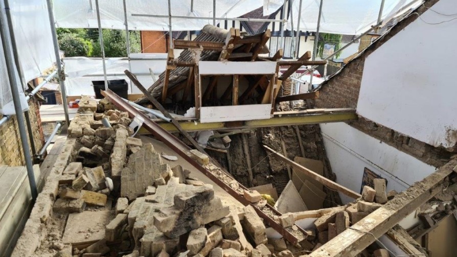 A construction site where a roof has collapsed on a home, there