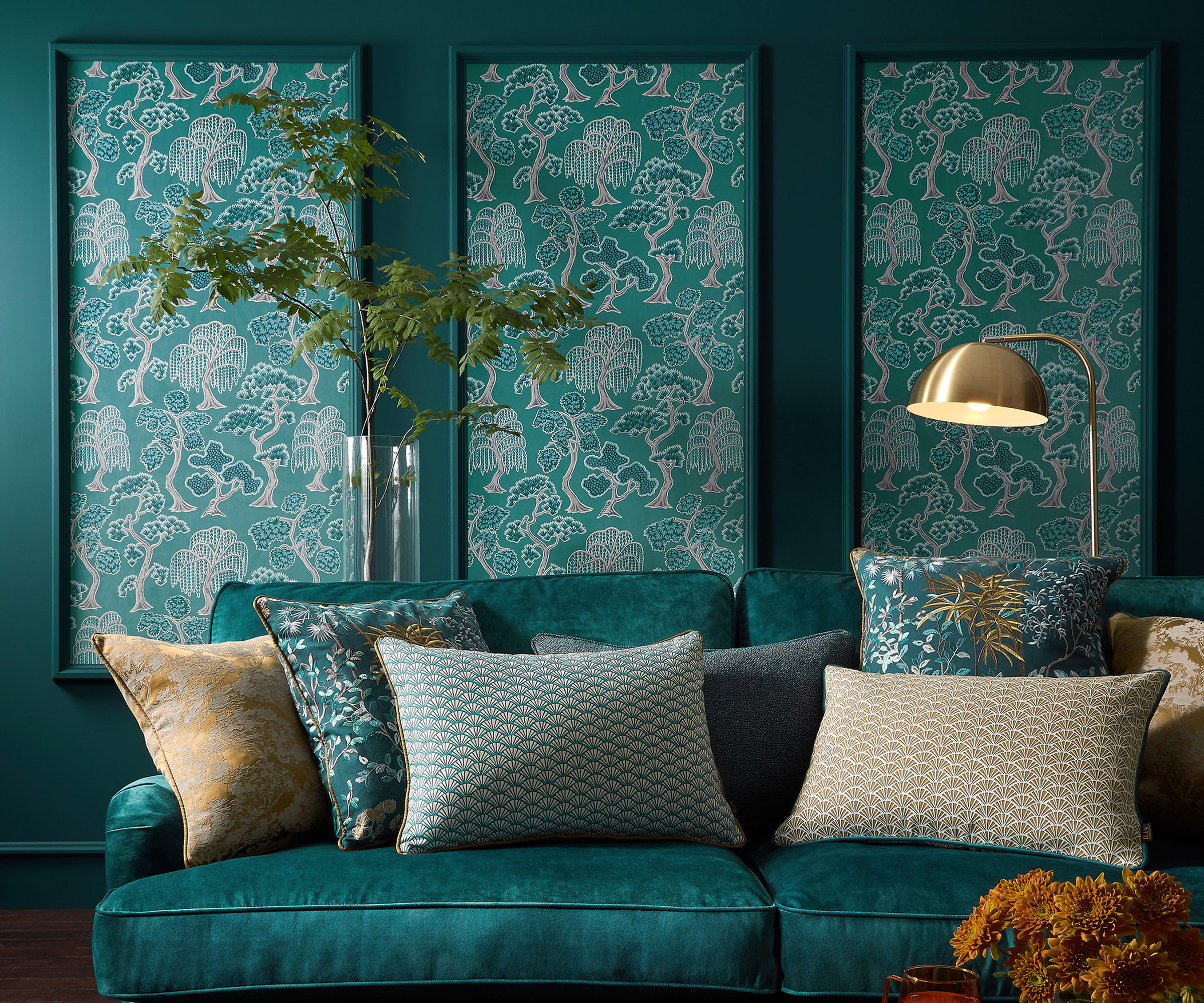 green living room with wallpapered wall panelling and jewel green velvet sofa