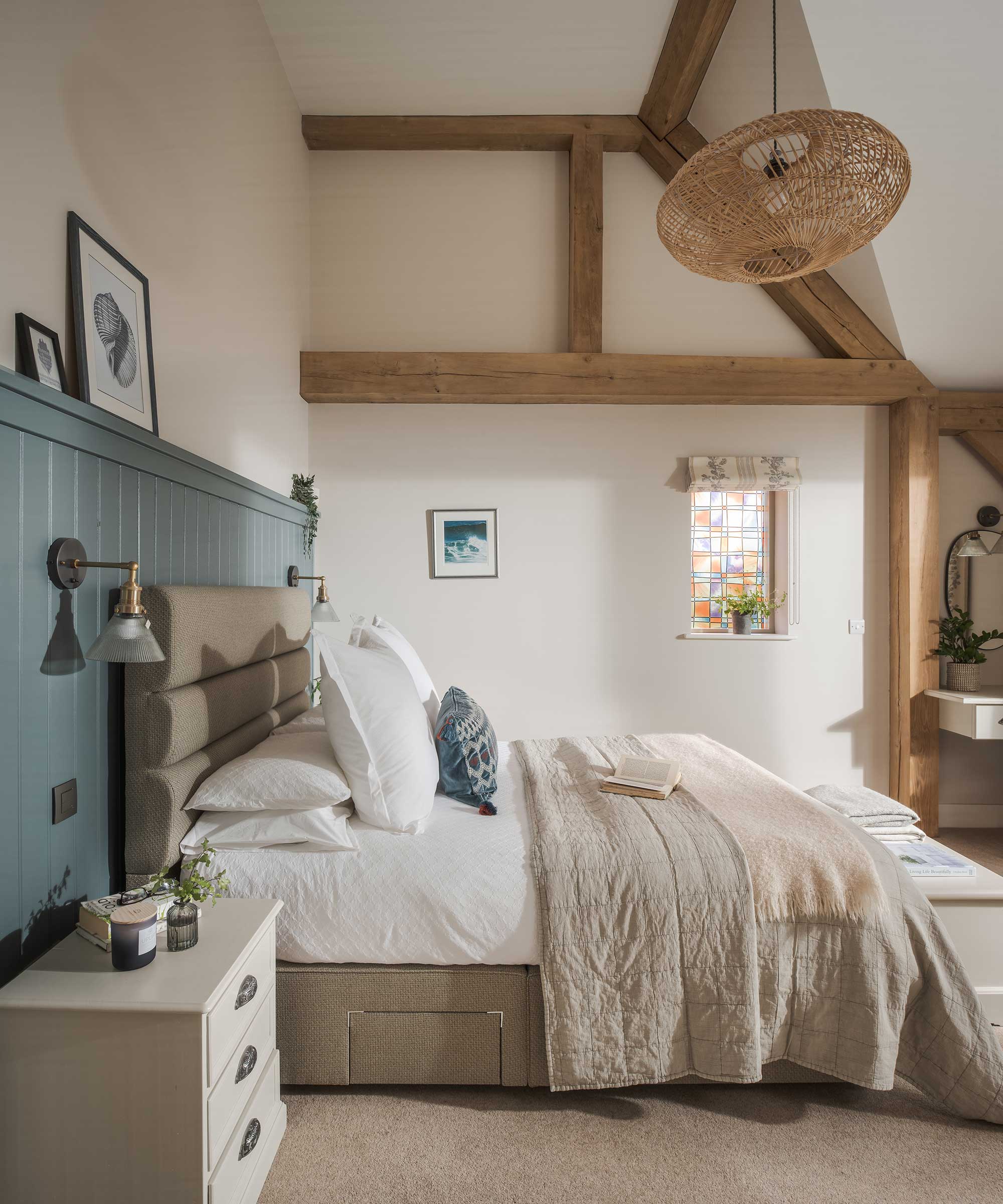 large bedroom in an oak frame home with oak beams on display