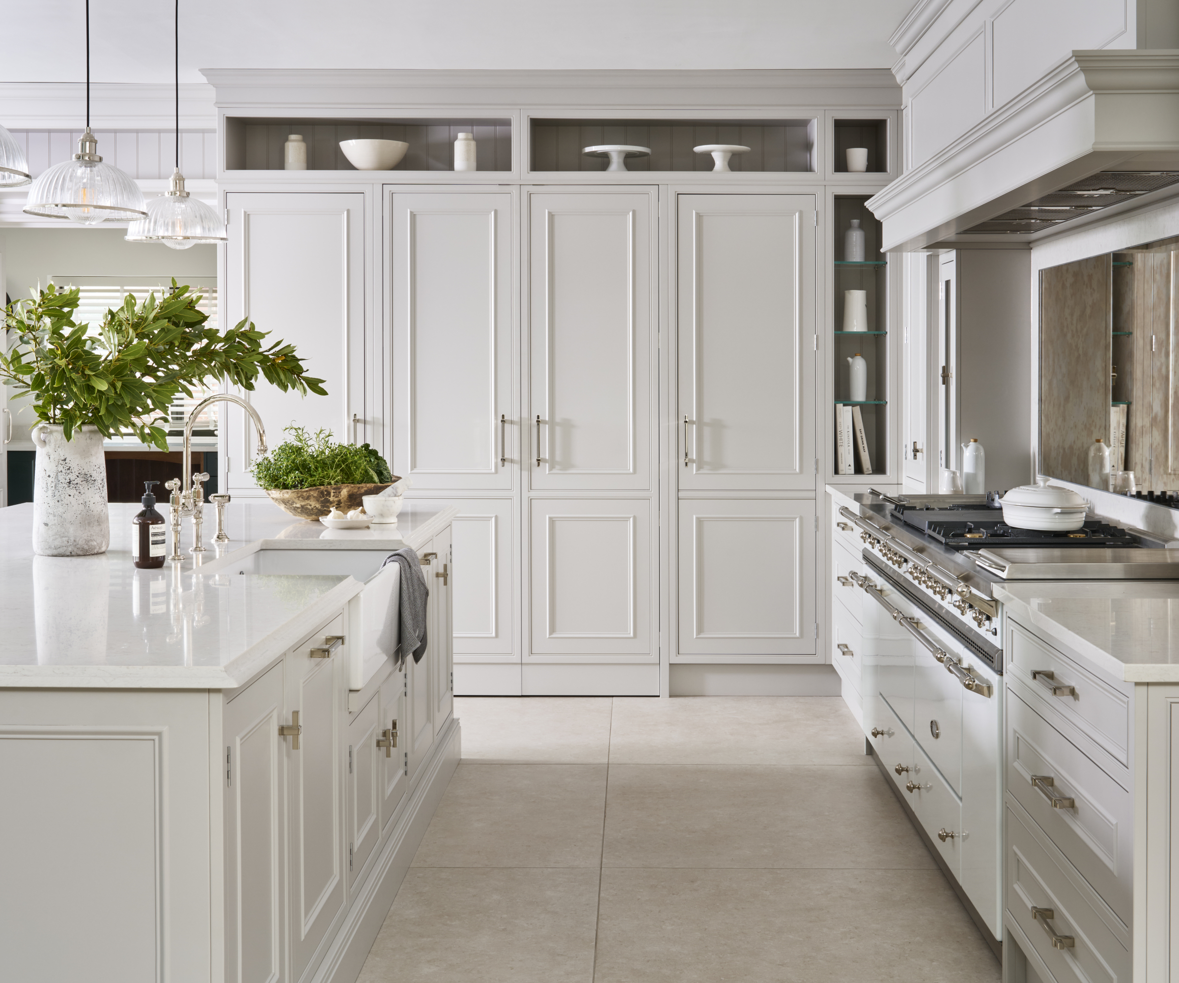 white shaker kitchen with matt chrome hardware and light tiled floor