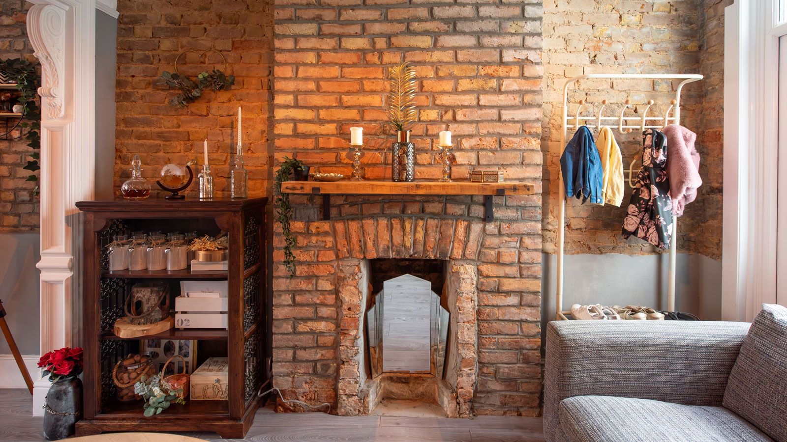 Old exposed brick wall with disused fireplace