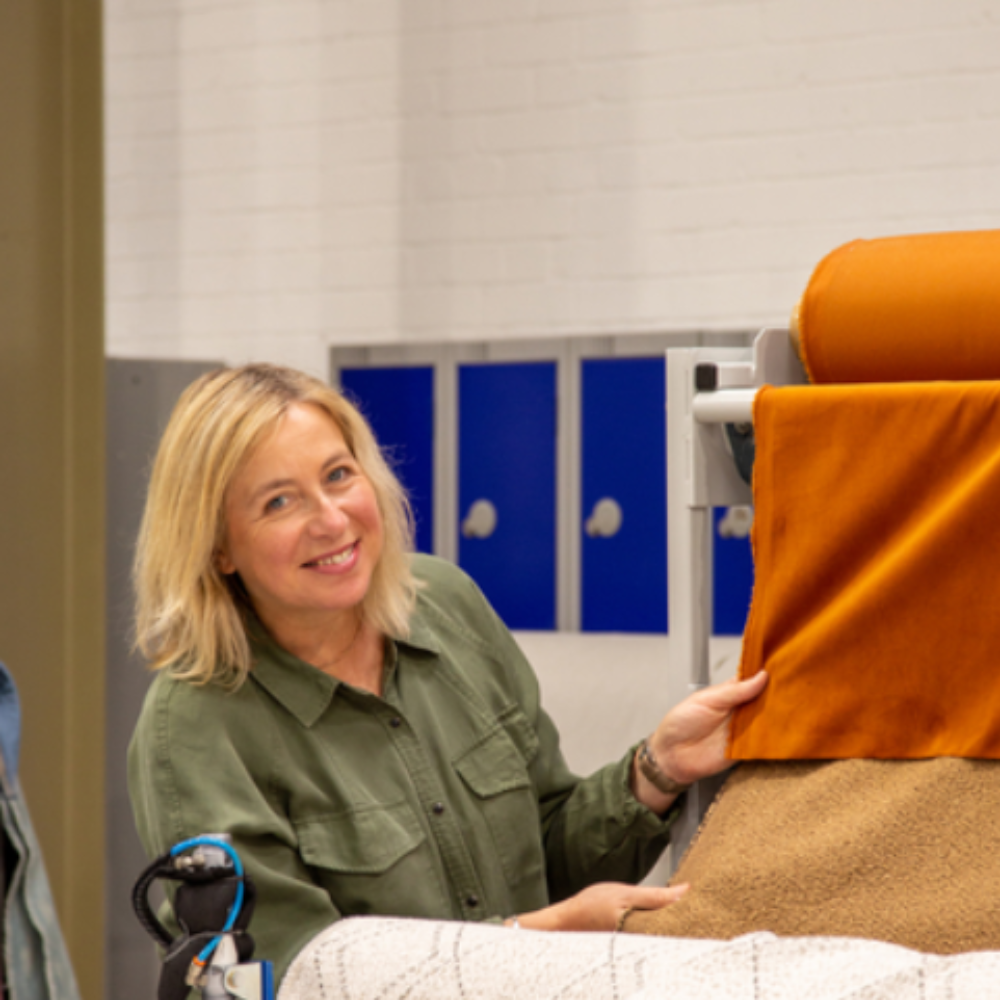 Yvonne Keal holding a piece of material on a roller