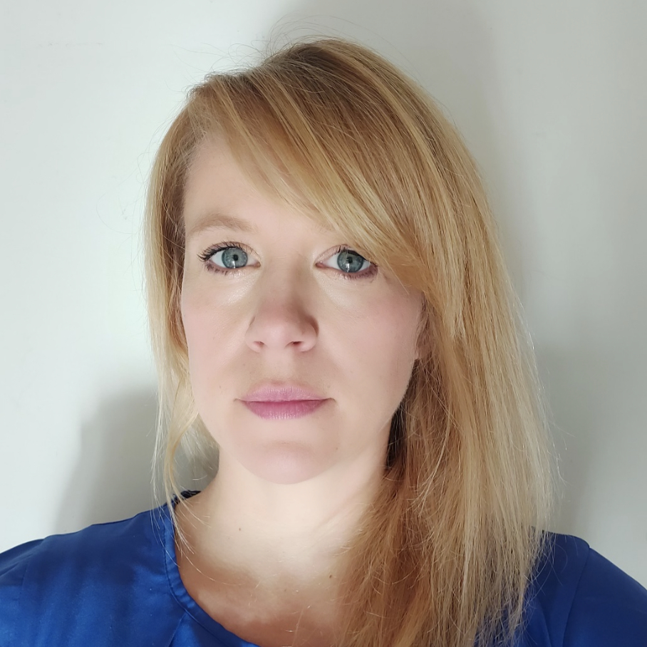 headshot of female with blond hair wearing blue top
