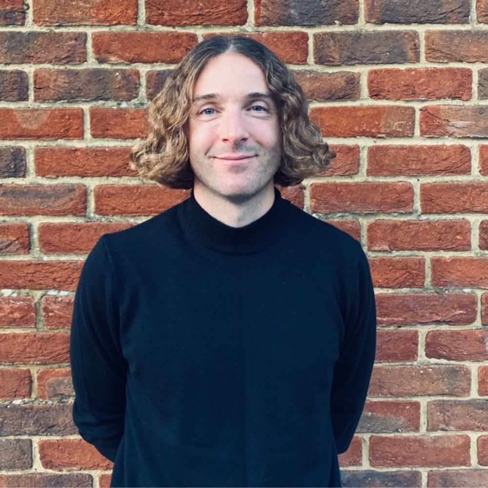 Headshot of Maxwell Wilson, the co-founder of Pocket Storage, against a brick wall