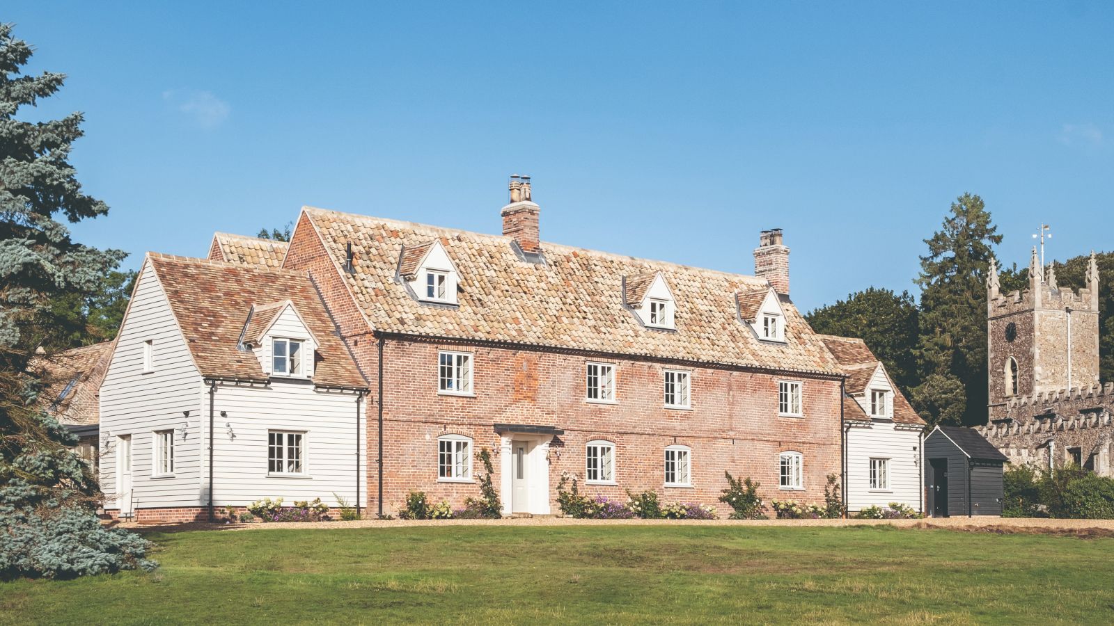 House exterior from east with church tower