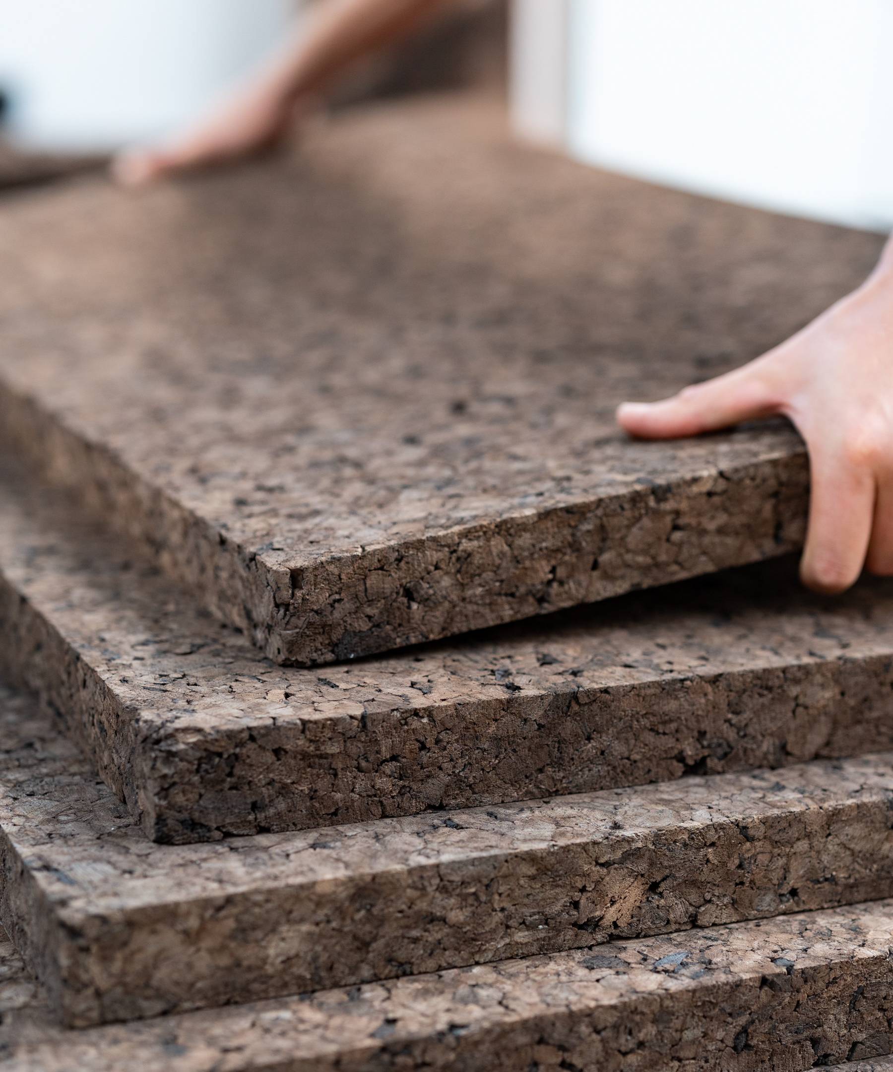 Stacking sheets of cork insulation.