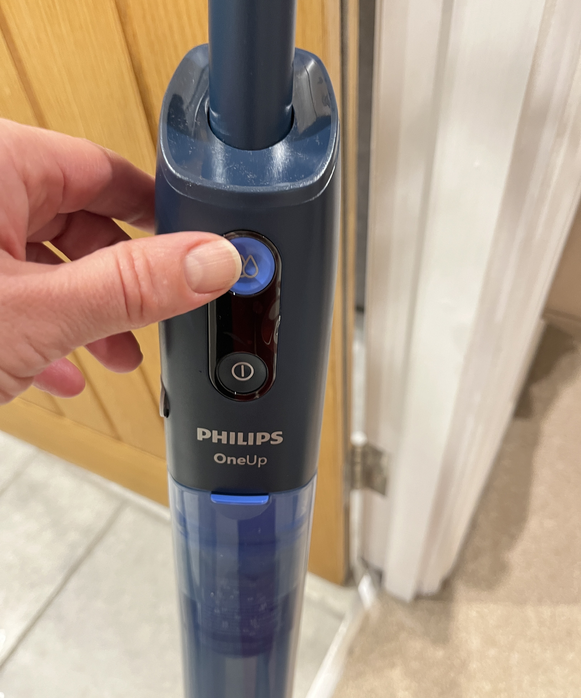 pressing the water strength button on the Philips OneUP 5000 series electric mop