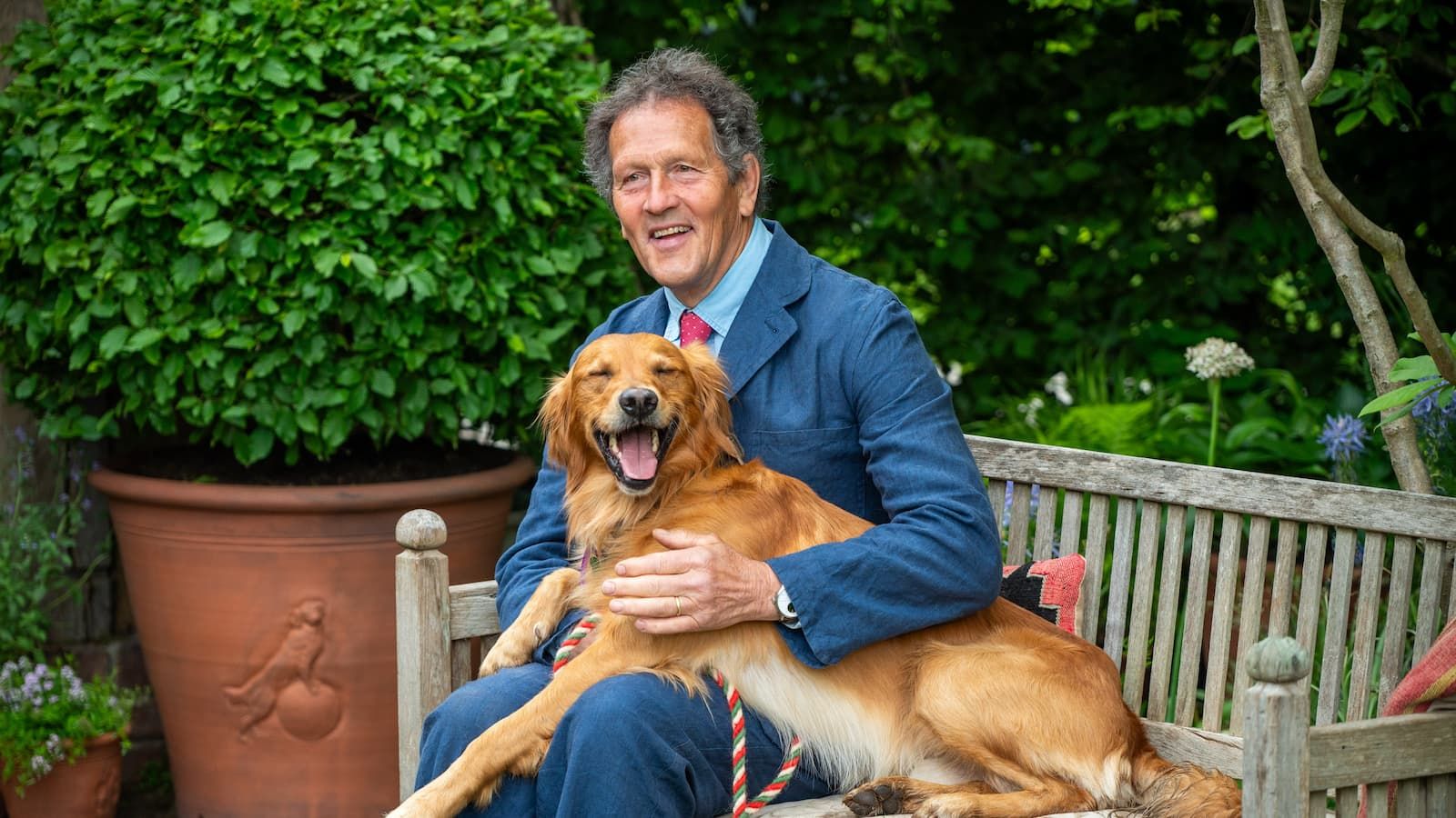 Monty Don has an informal moment with his Golden Retriever Ned on the RHS and BBC Radio 2 Dog Garden at RHS Chelsea
