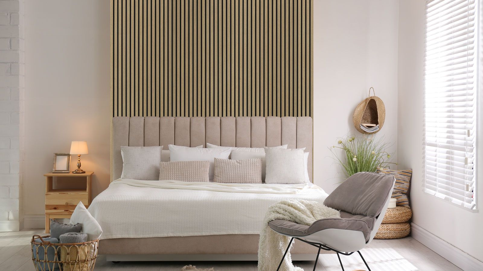 Modern bedroom with pink bed and bare wood vertical slat wall panelling