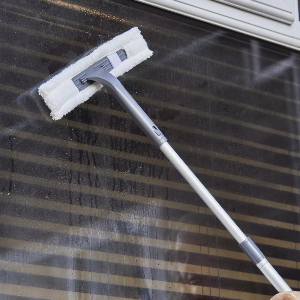 Swan cordless vacuum with extension pole on window