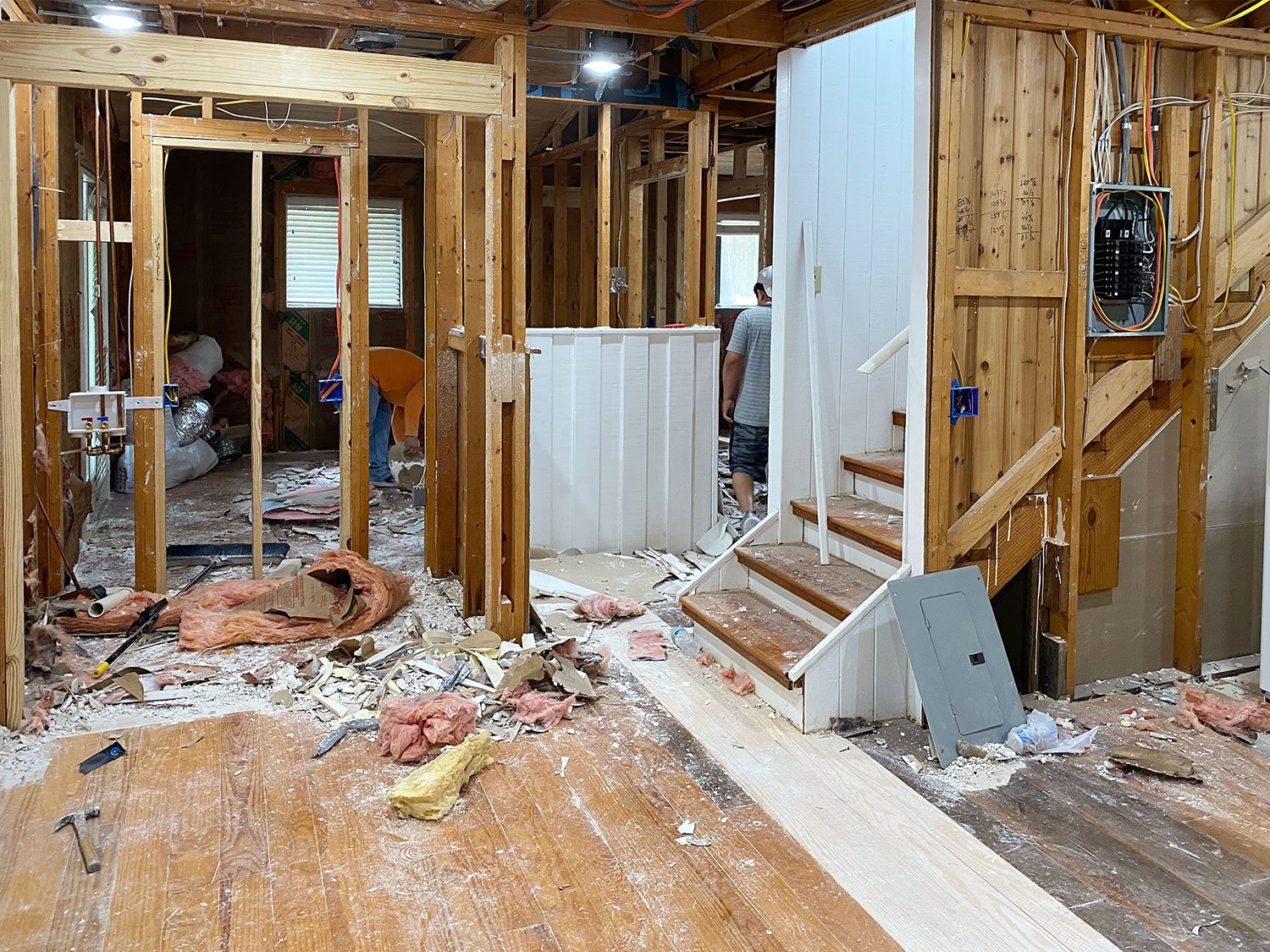 Renovation Photo With House That Has Exposed Beams And No Drywall And Dusty Floors