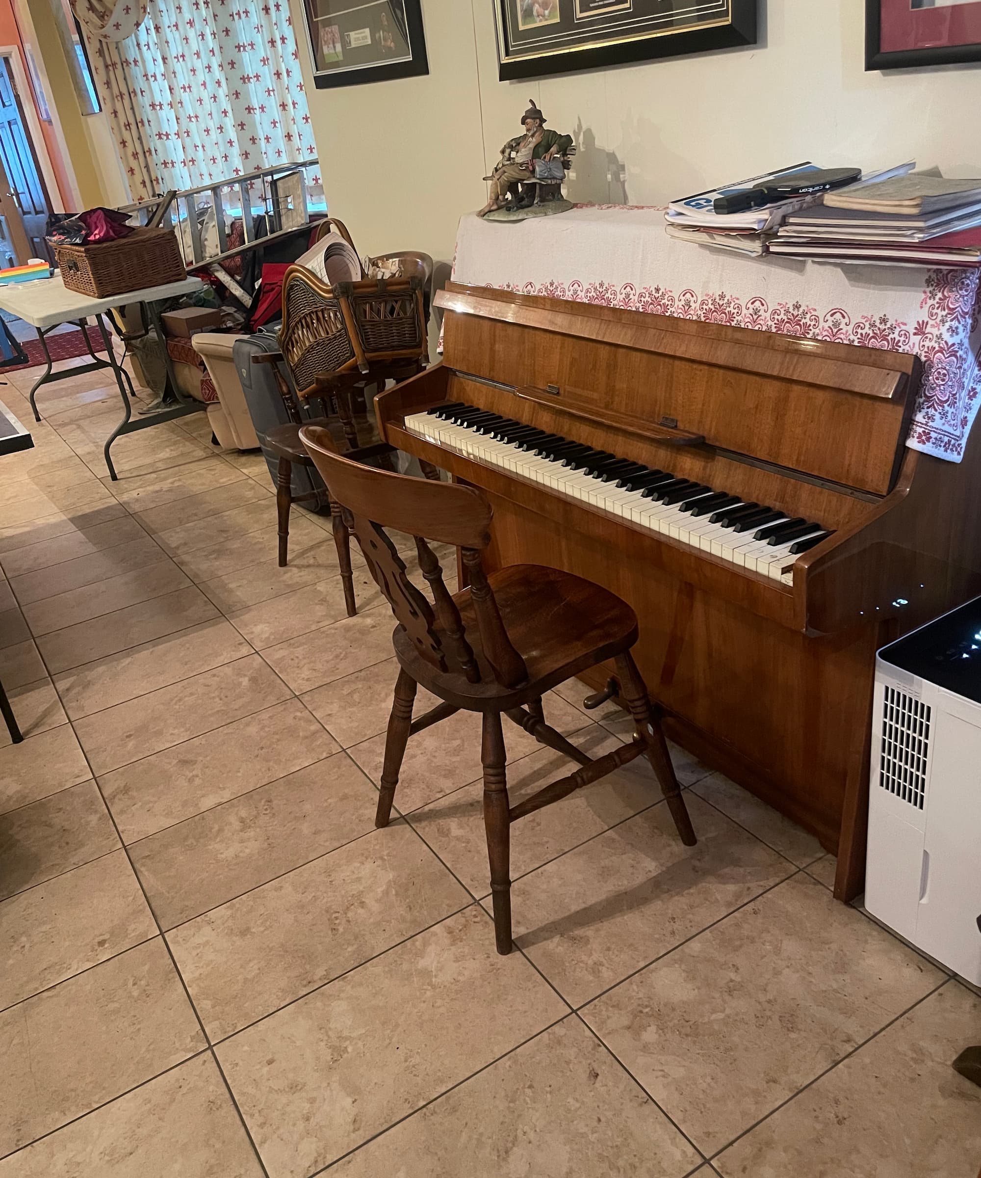 A Duux Bora Smart Dehumidifier standing next to a piano