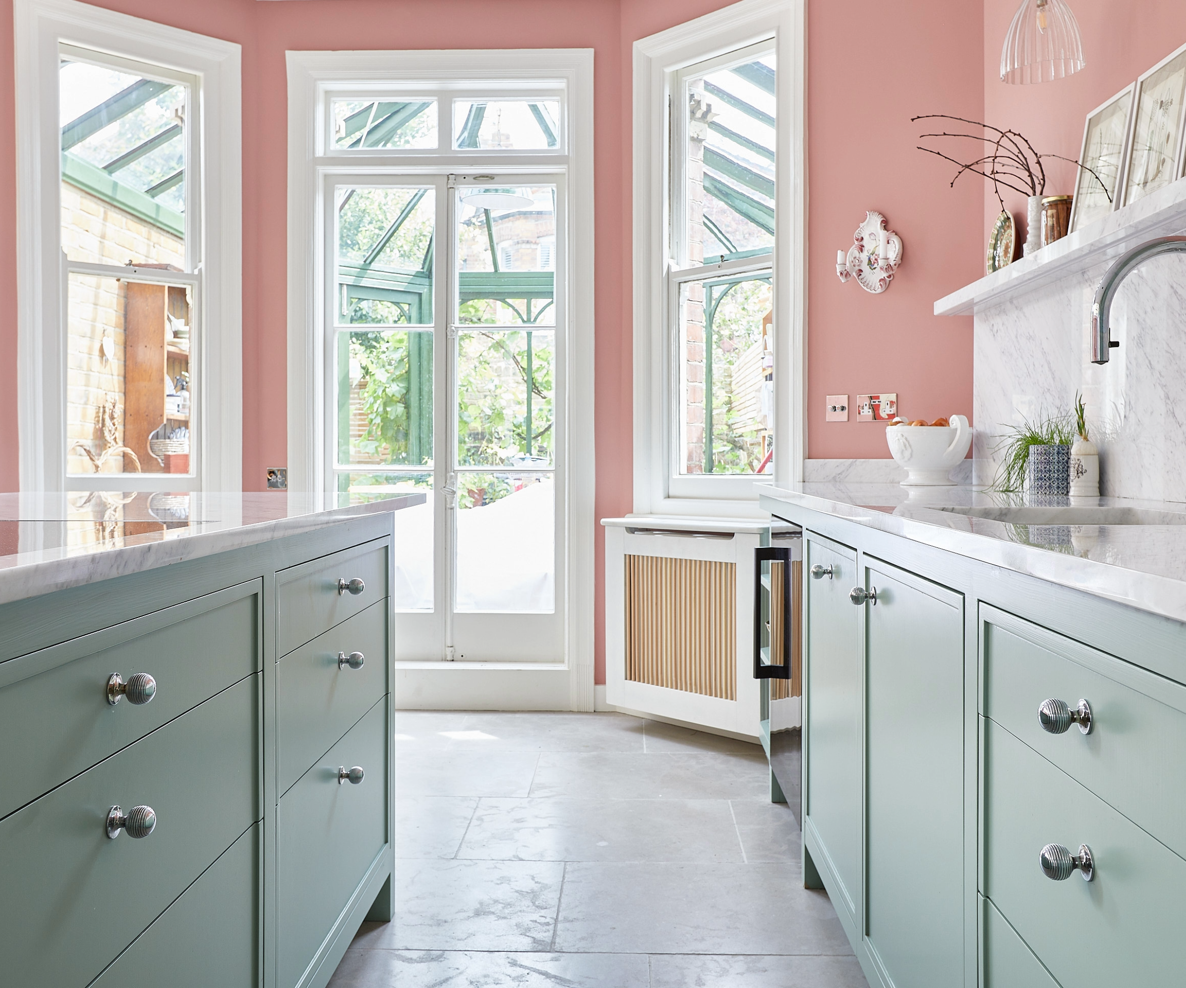 Kitchen with pink walls and green cabinets