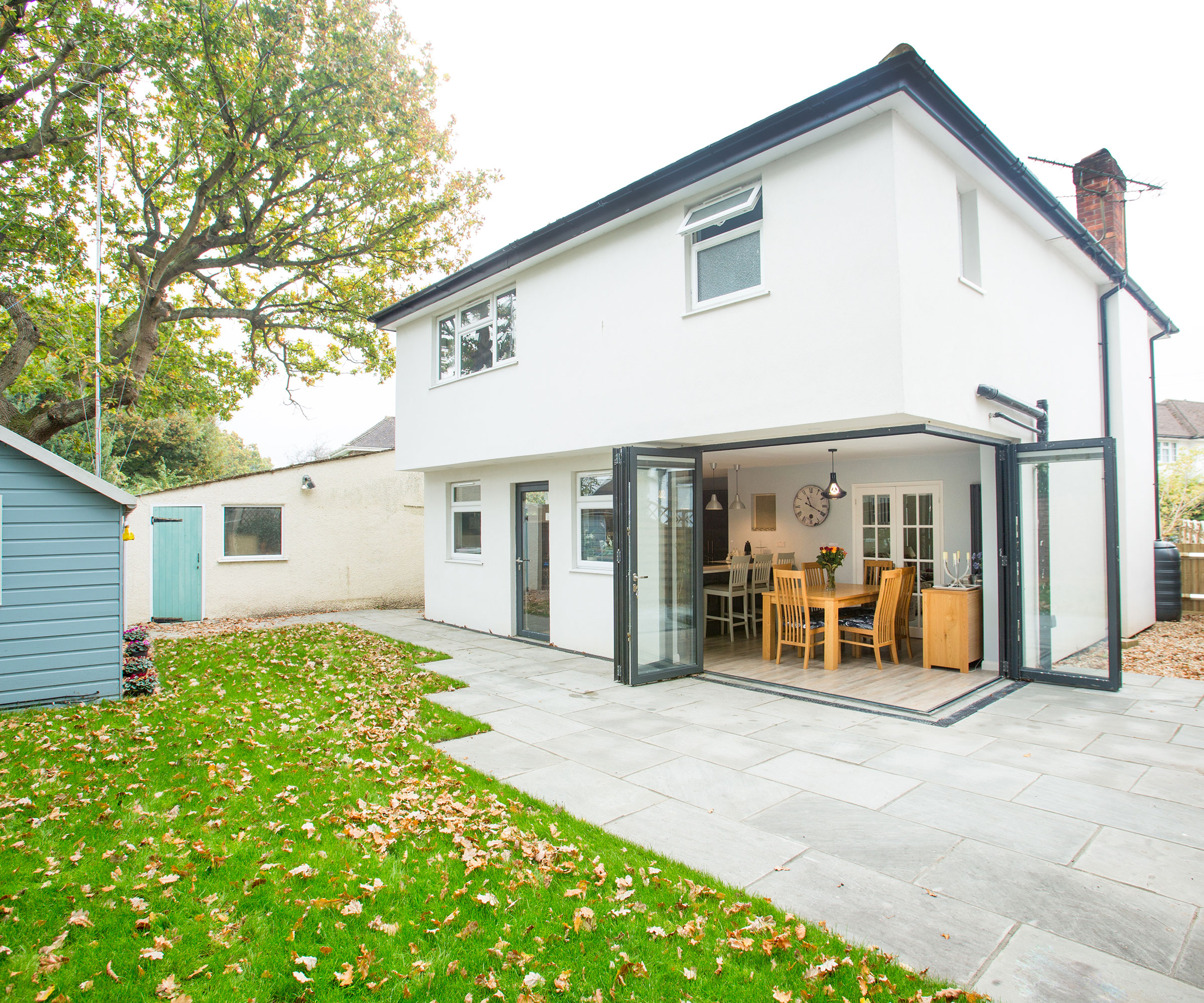 white rendered renovated 1950s house with corner opening bi fold doors