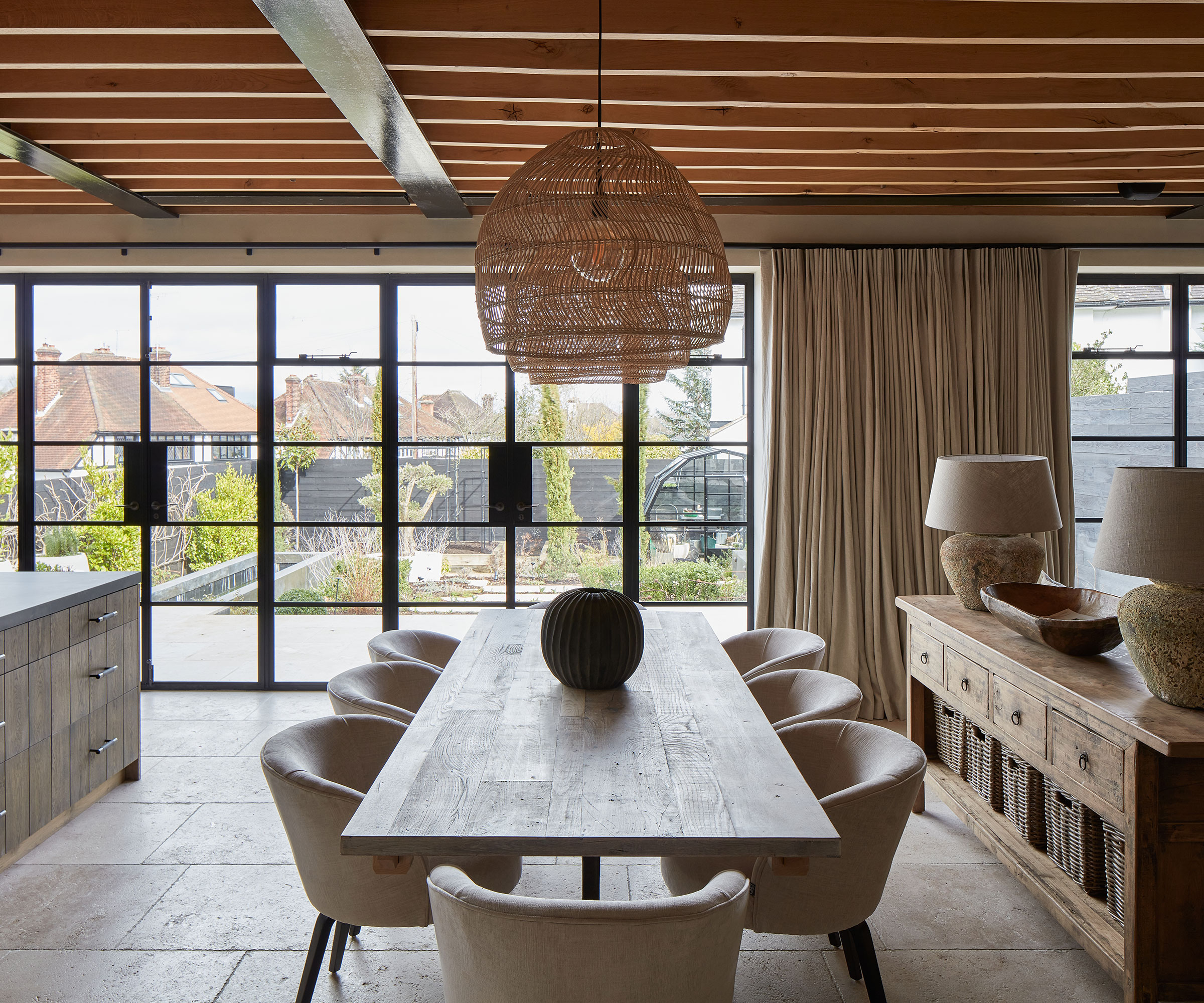 wooden kitchen diner with metal framed windows to outside