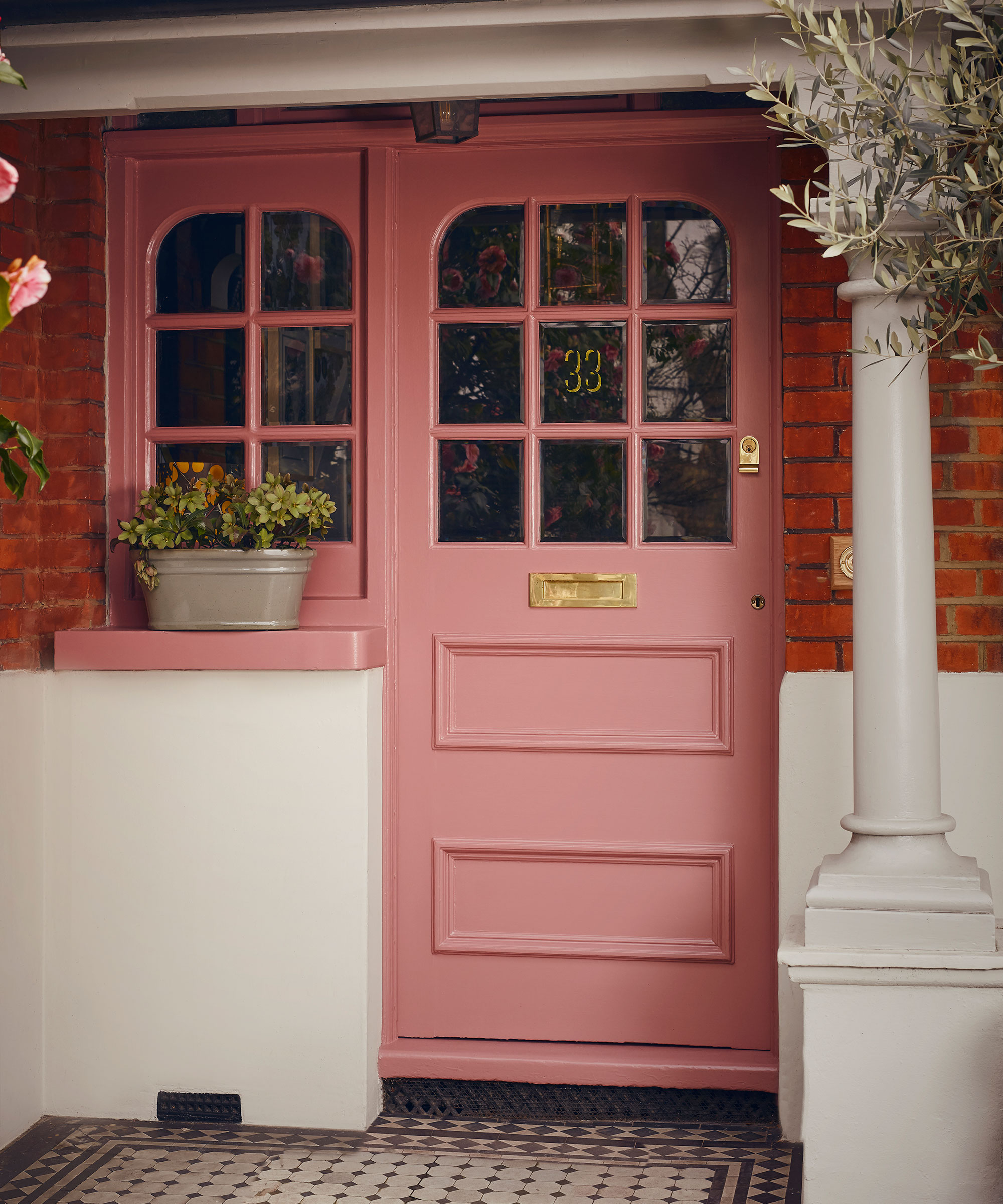 Pink front door with black and white doorstep