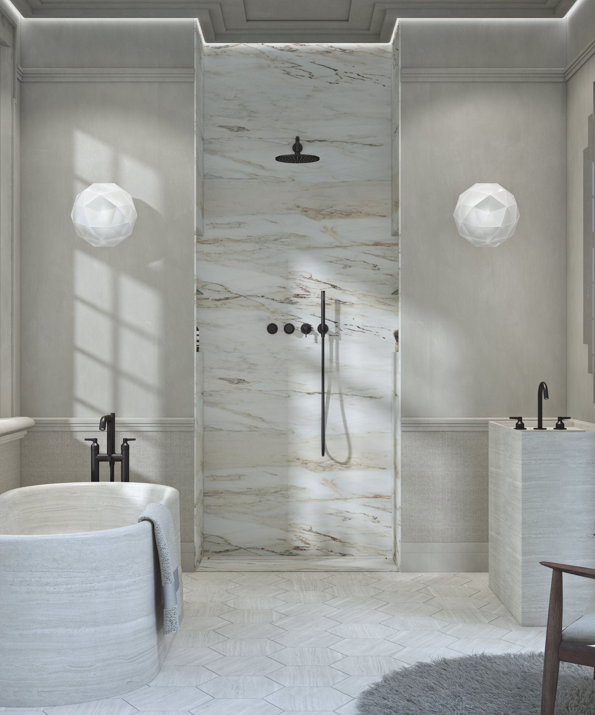 A refined marble bathroom with a walk-in shower, sculptural stone bath and basin, soft grey walls and black fittings, creating a calm, spa-like atmosphere.