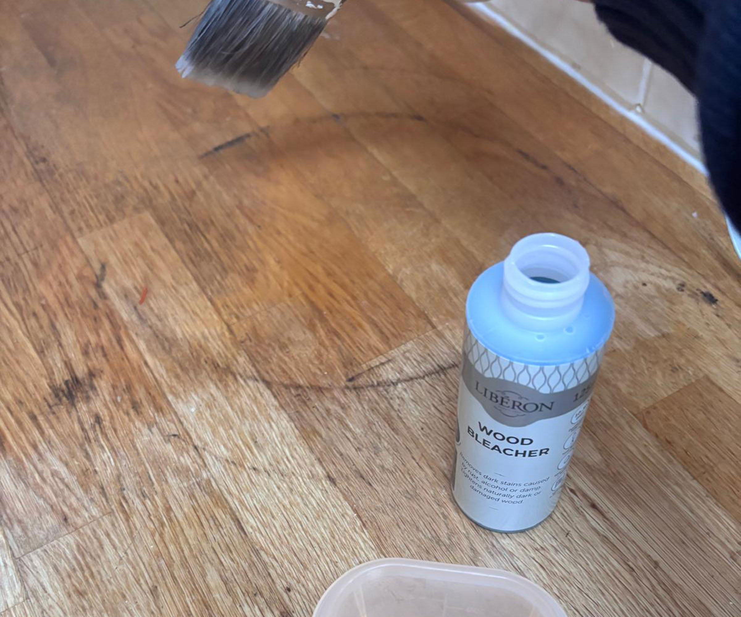 applying wood bleach to black rings on wooden worktops