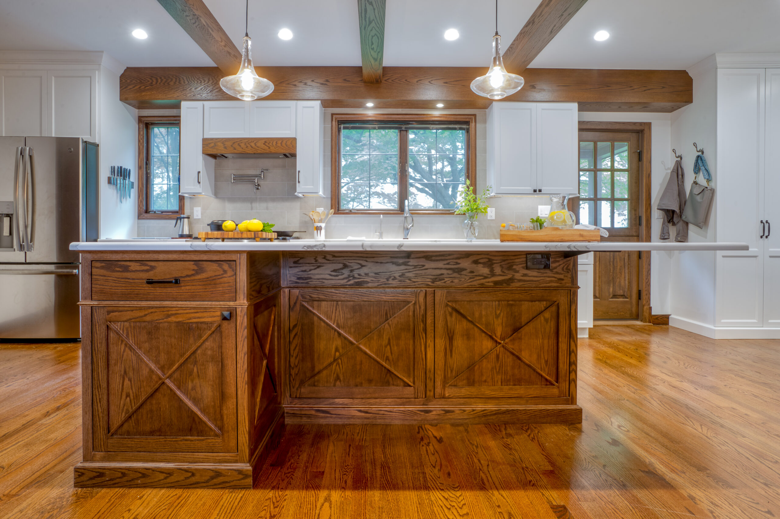 Kitchen with wooden cabinetry, wooden flooring, and warm lighting